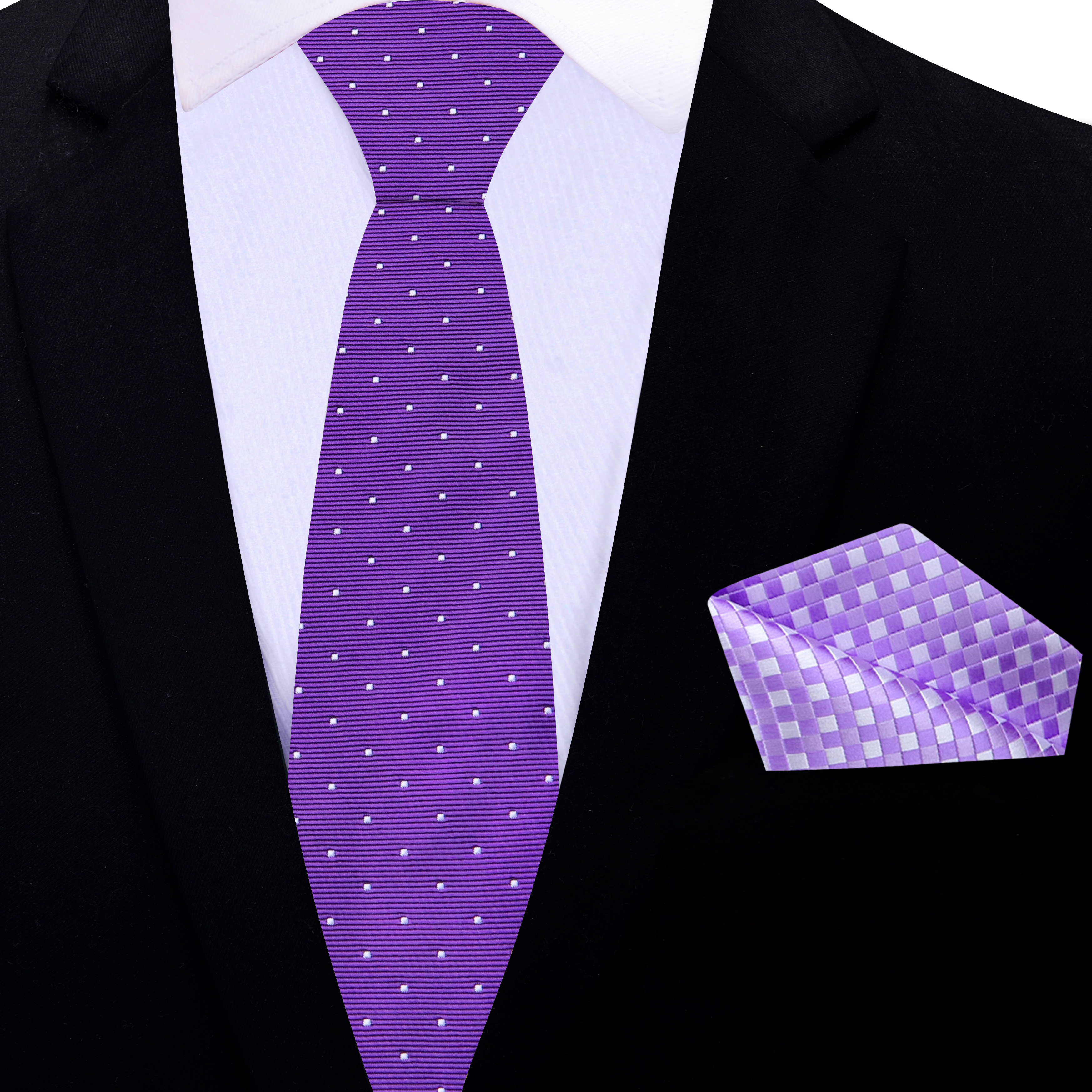 Styled photo of the purple tie paired with a light grey shirt and charcoal suit, showcasing versatility.