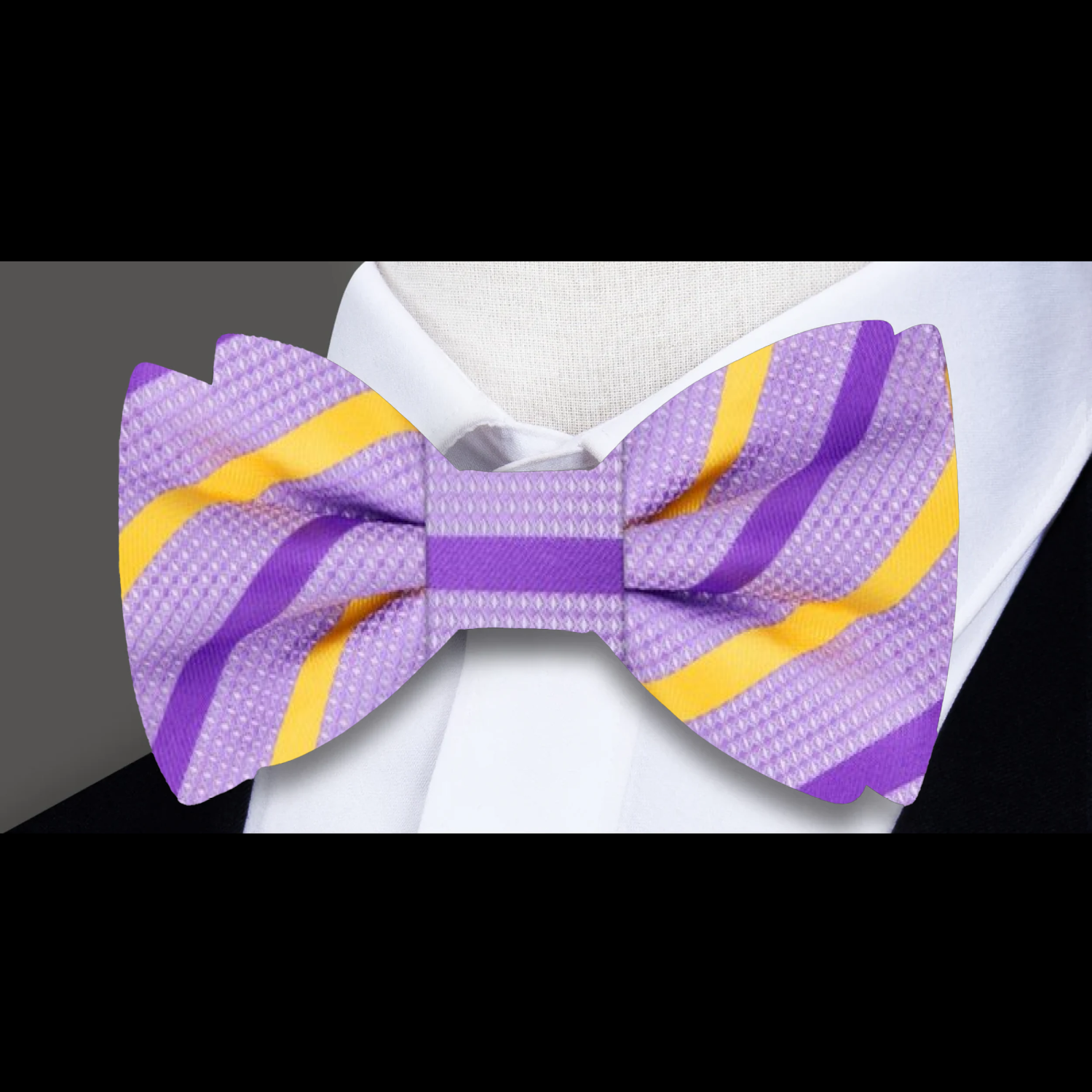 Fashionable purple and yellow striped bow tie styled with a crisp white dress shirt