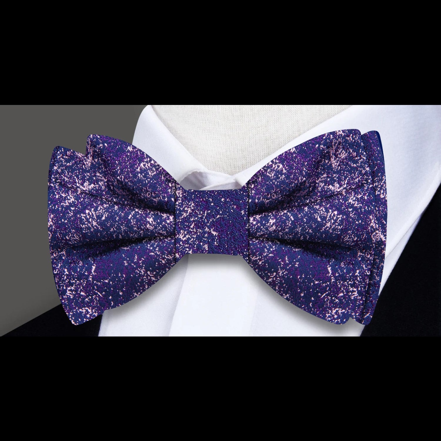 Artistic Elegance Bow Tie with red and blue abstract pattern, elegantly displayed on a suit.