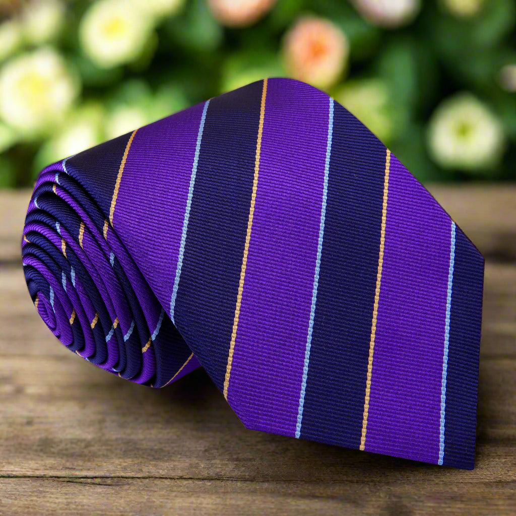 Close-up of the elegant purple and dark blue stripe necktie, showcasing its rich fabric and design.