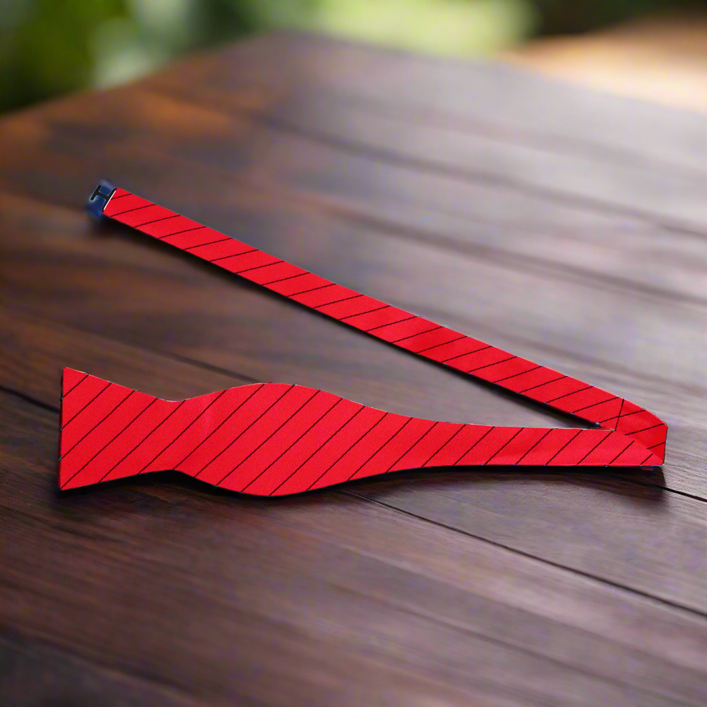 Flat lay of white and black striped bow ties with matching pocket squares, ideal for formal occasions.