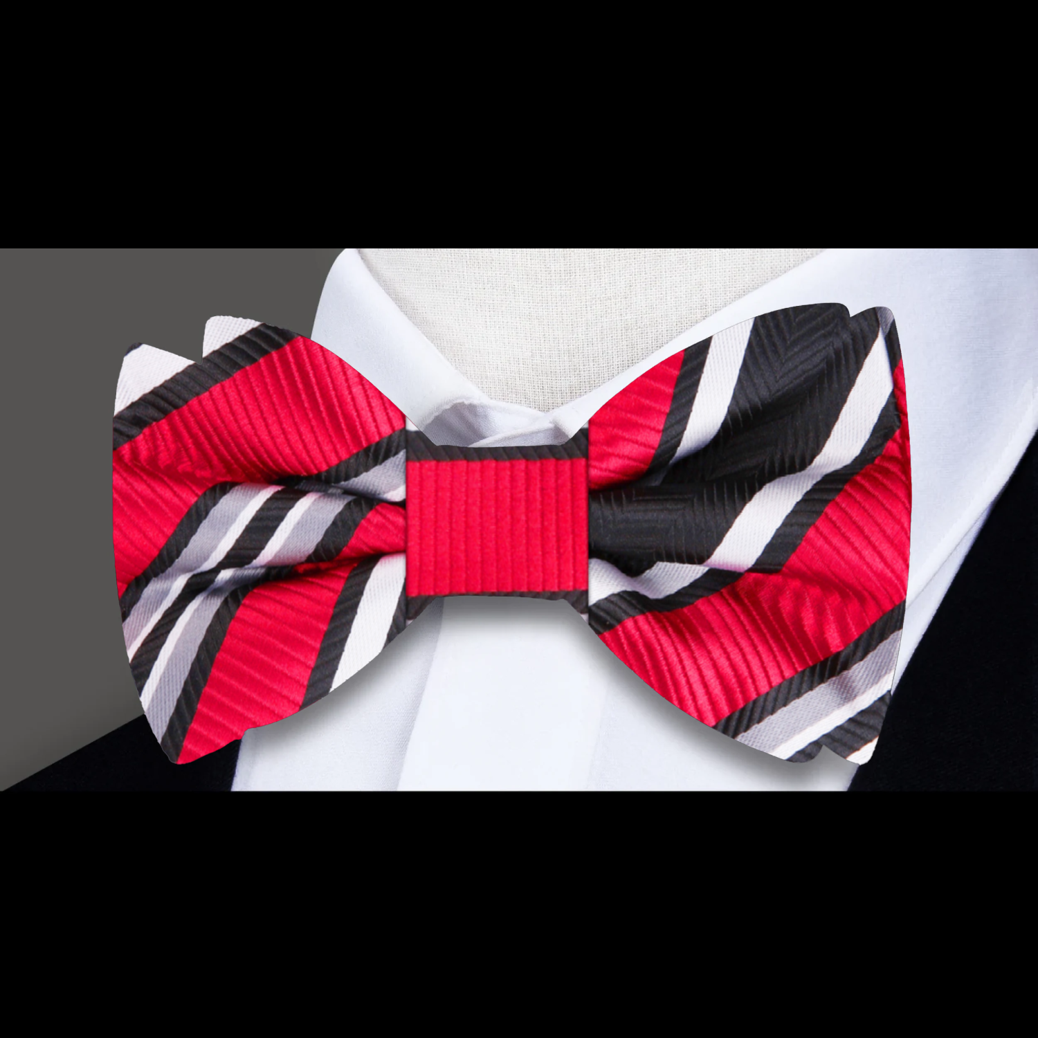 Model wearing the self-tie Delta Stripe Bow Tie paired with a suit for a formal event.