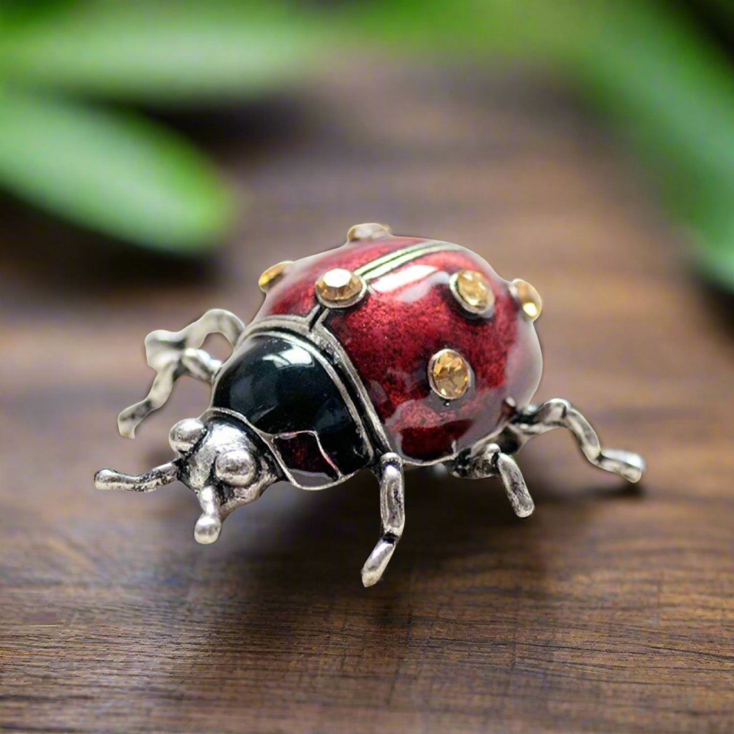 Close-up of the charming ladybug lapel pin showcasing intricate details in black and red.
