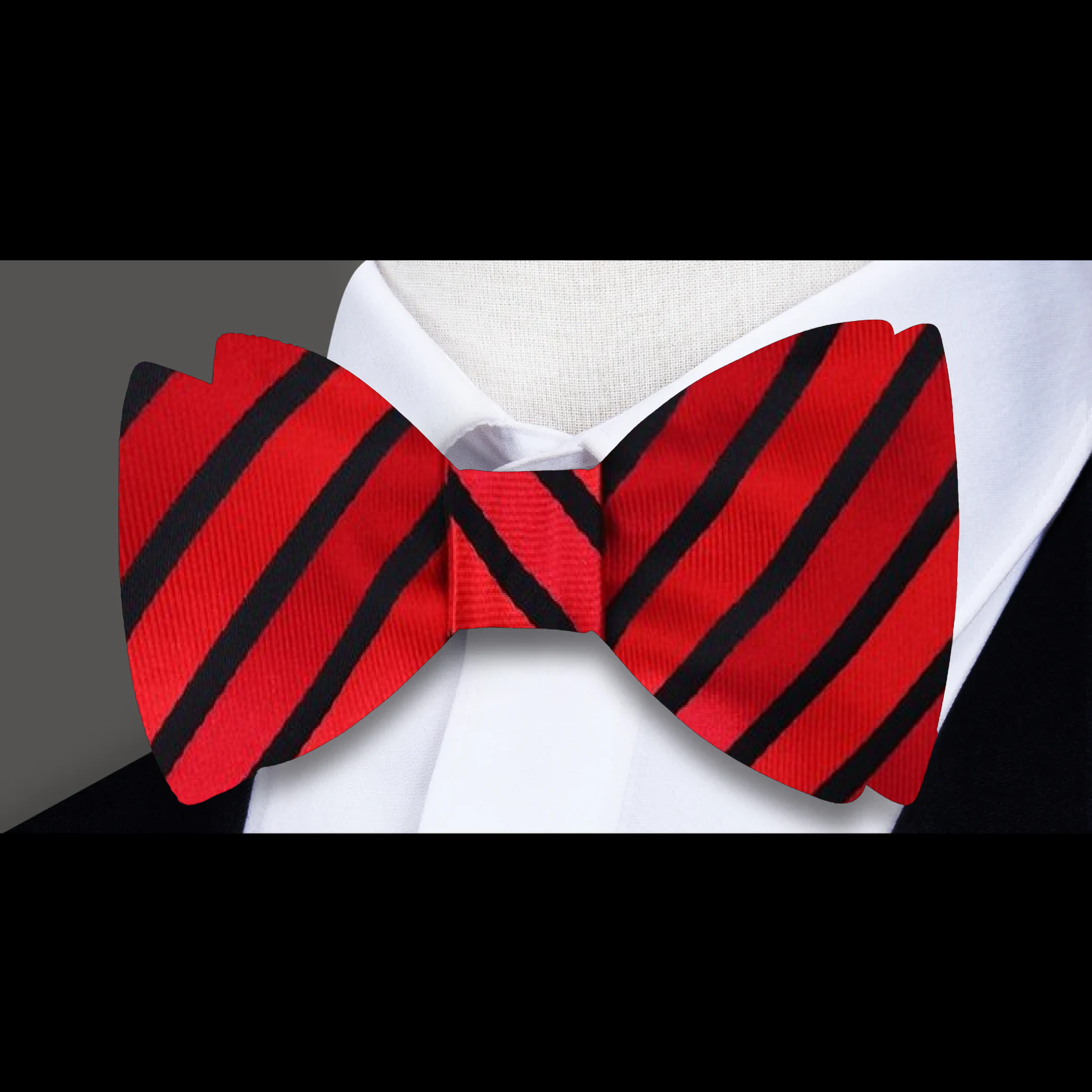 Dynamic view of the yellow and dark blue striped bow tie against a light blue dress shirt.