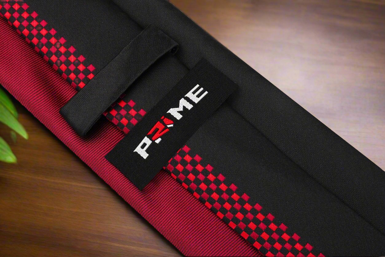 The black and red checkered necktie displayed flat, highlighting its elegant design and silk material.