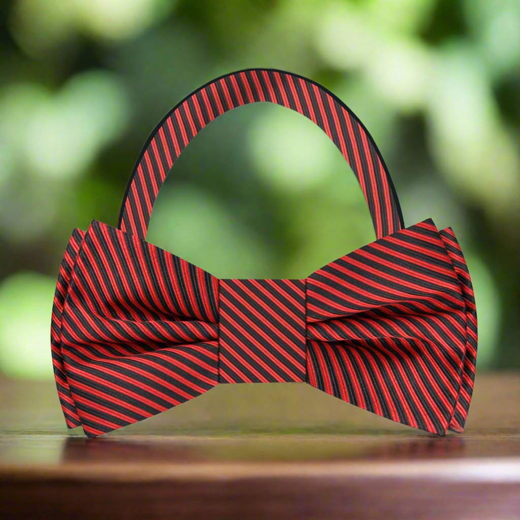 Elegant black and red pinstripe silk bow tie worn with a formal suit