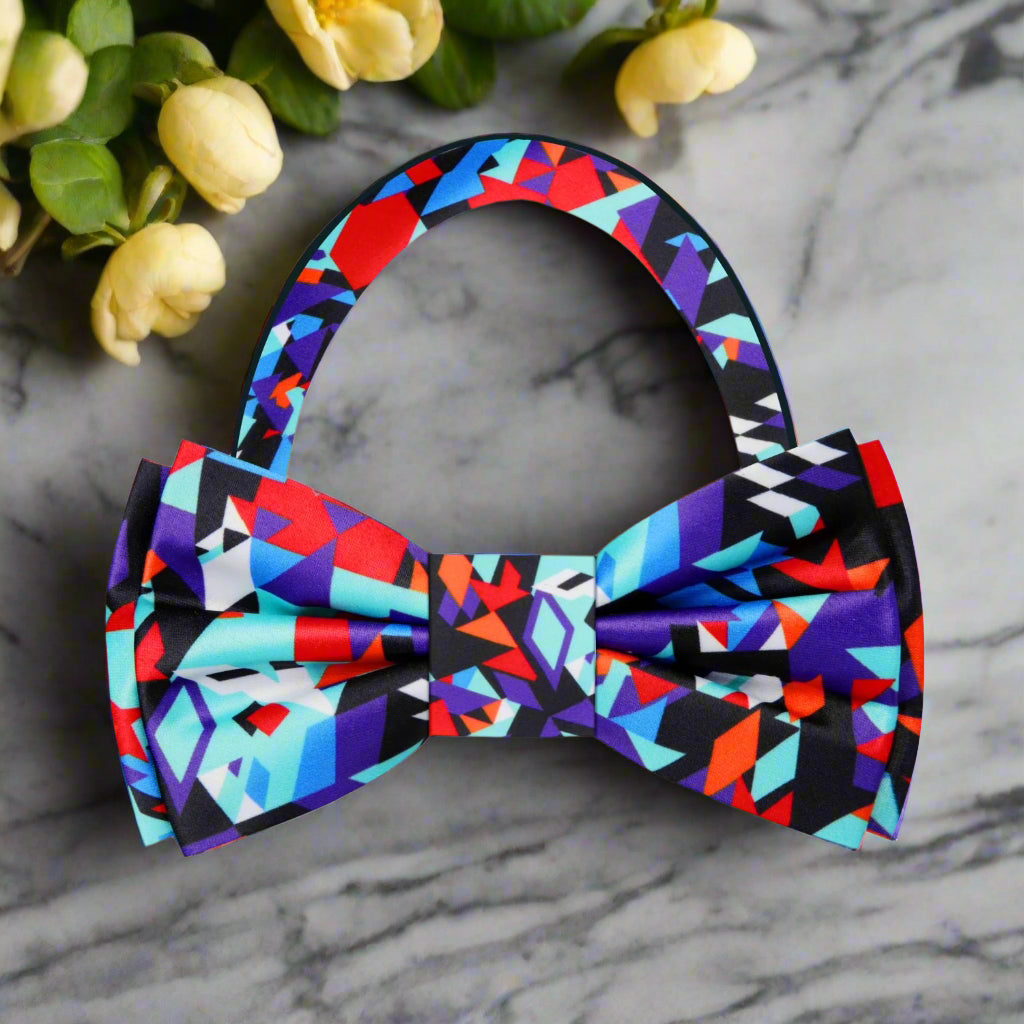 Close-up of a vibrant abstract silk bow tie with bold colors and intricate pattern