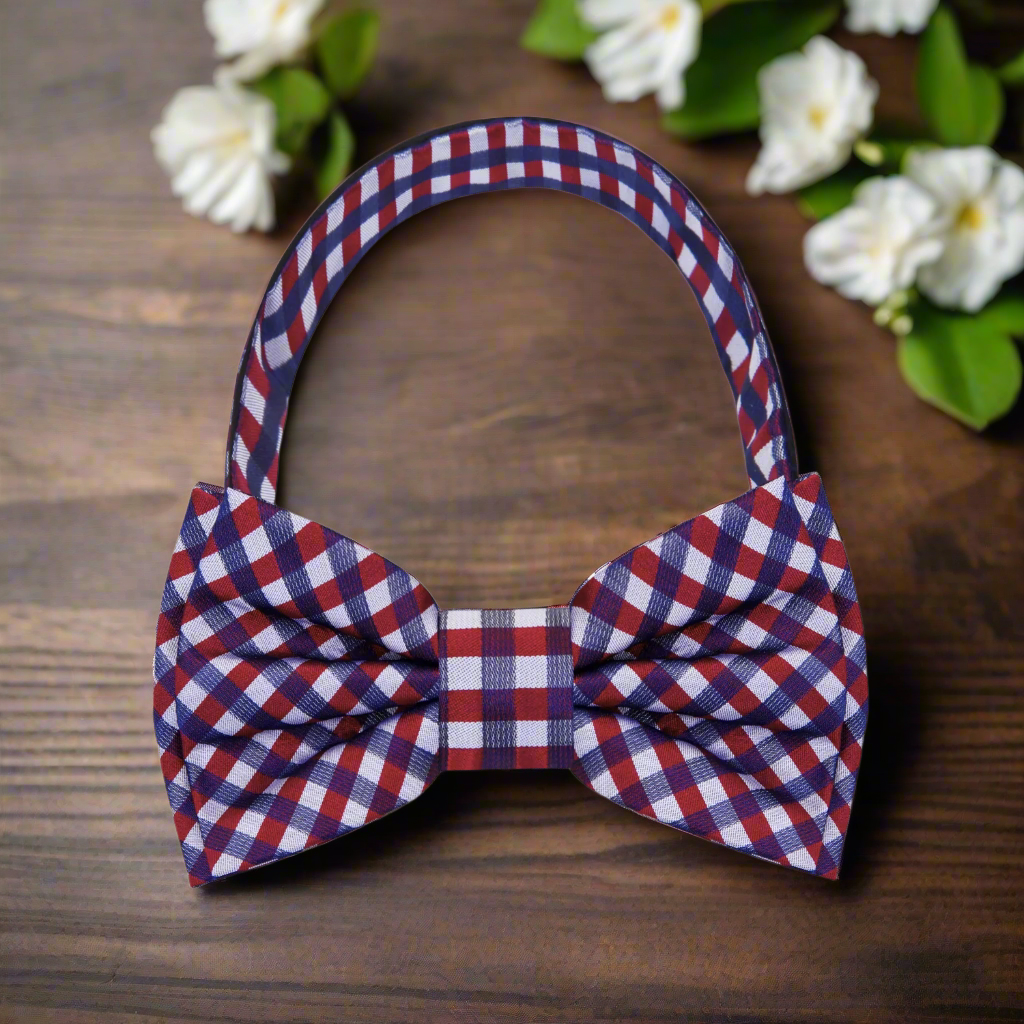Detailed shot of a red and blue plaid bow tie with a crisp shirt