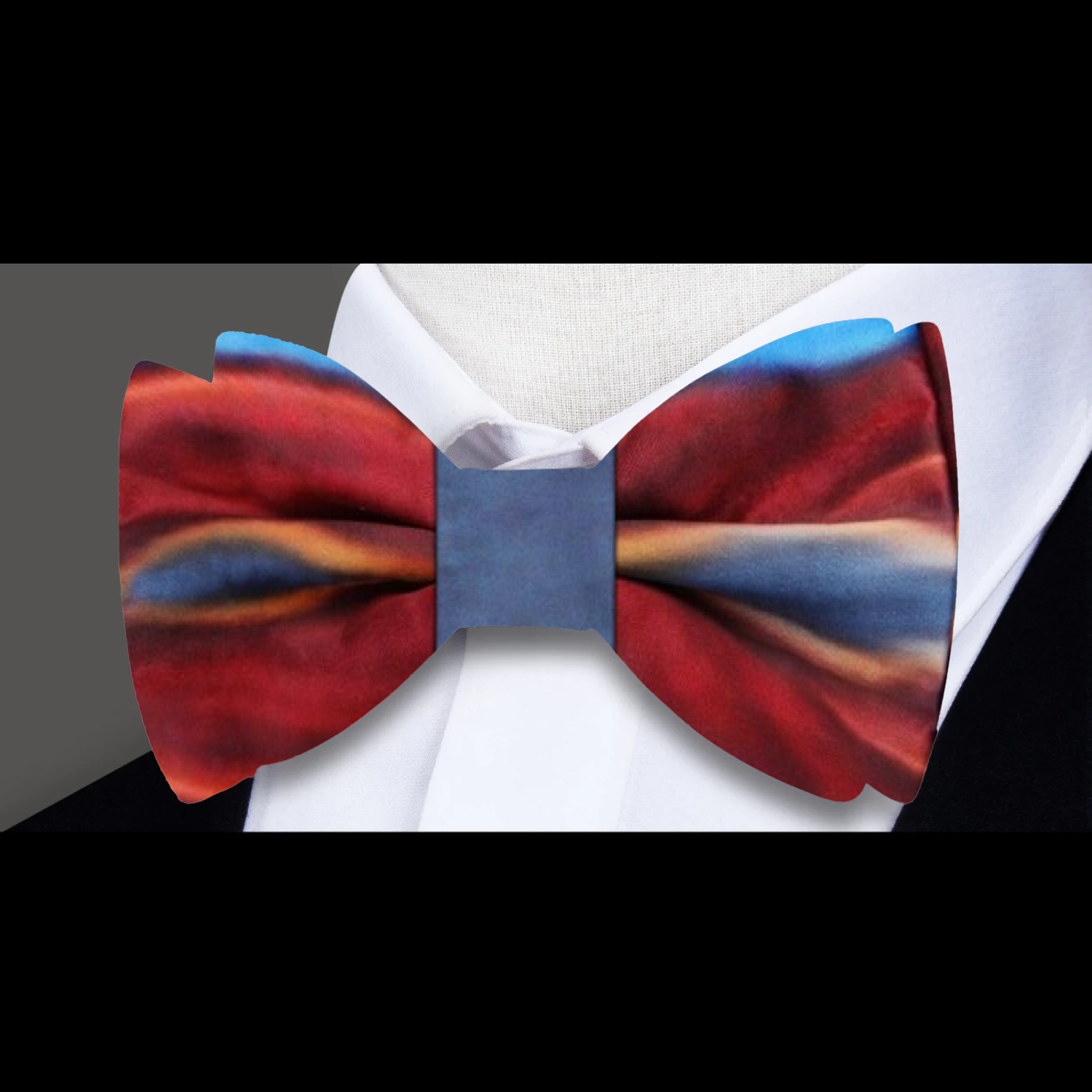 Adjustable silk bow tie paired with a matching pocket square, styled on a formal shirt and blazer.