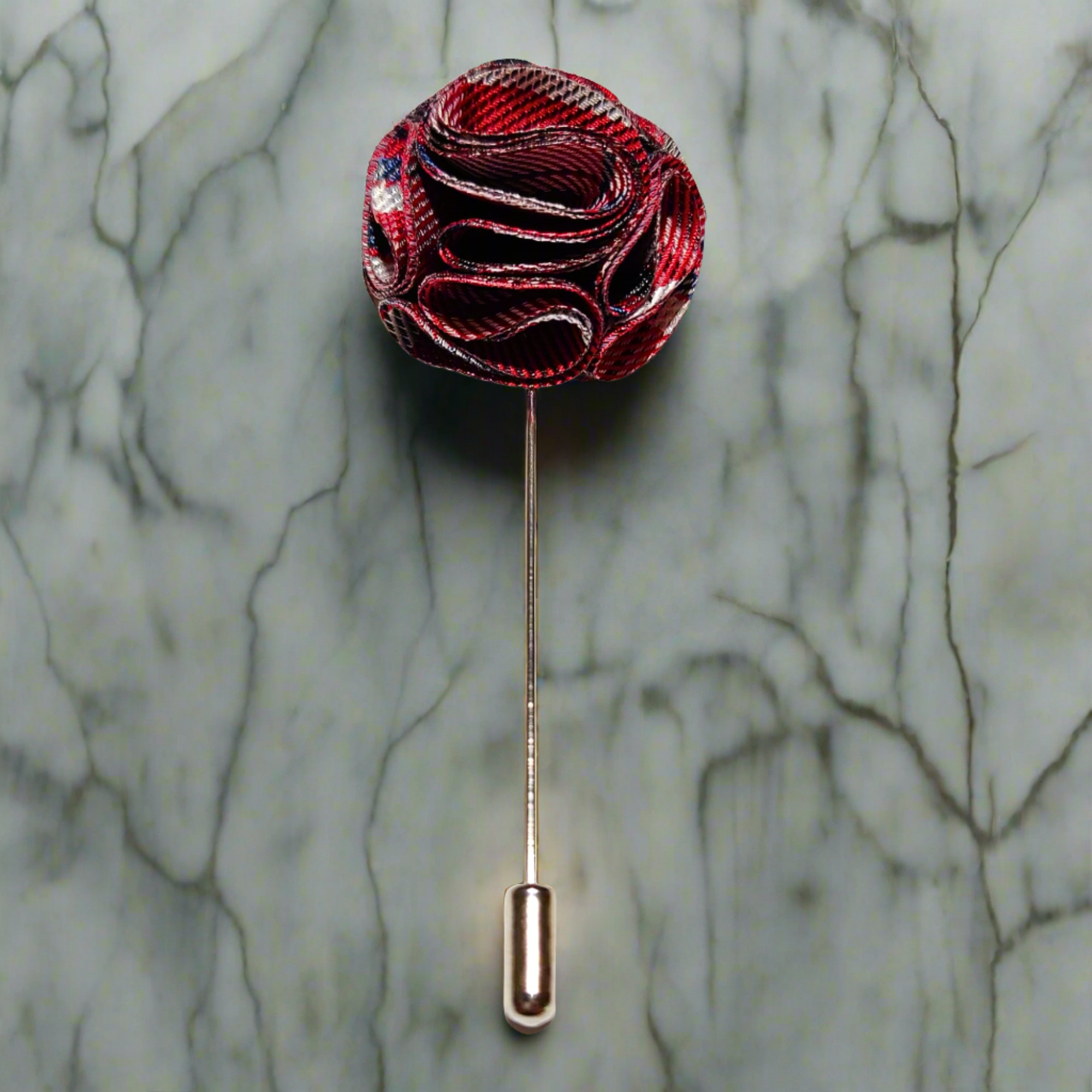 Fabric flower lapel pin on a dark suit, showing detailed petals and secure fastening