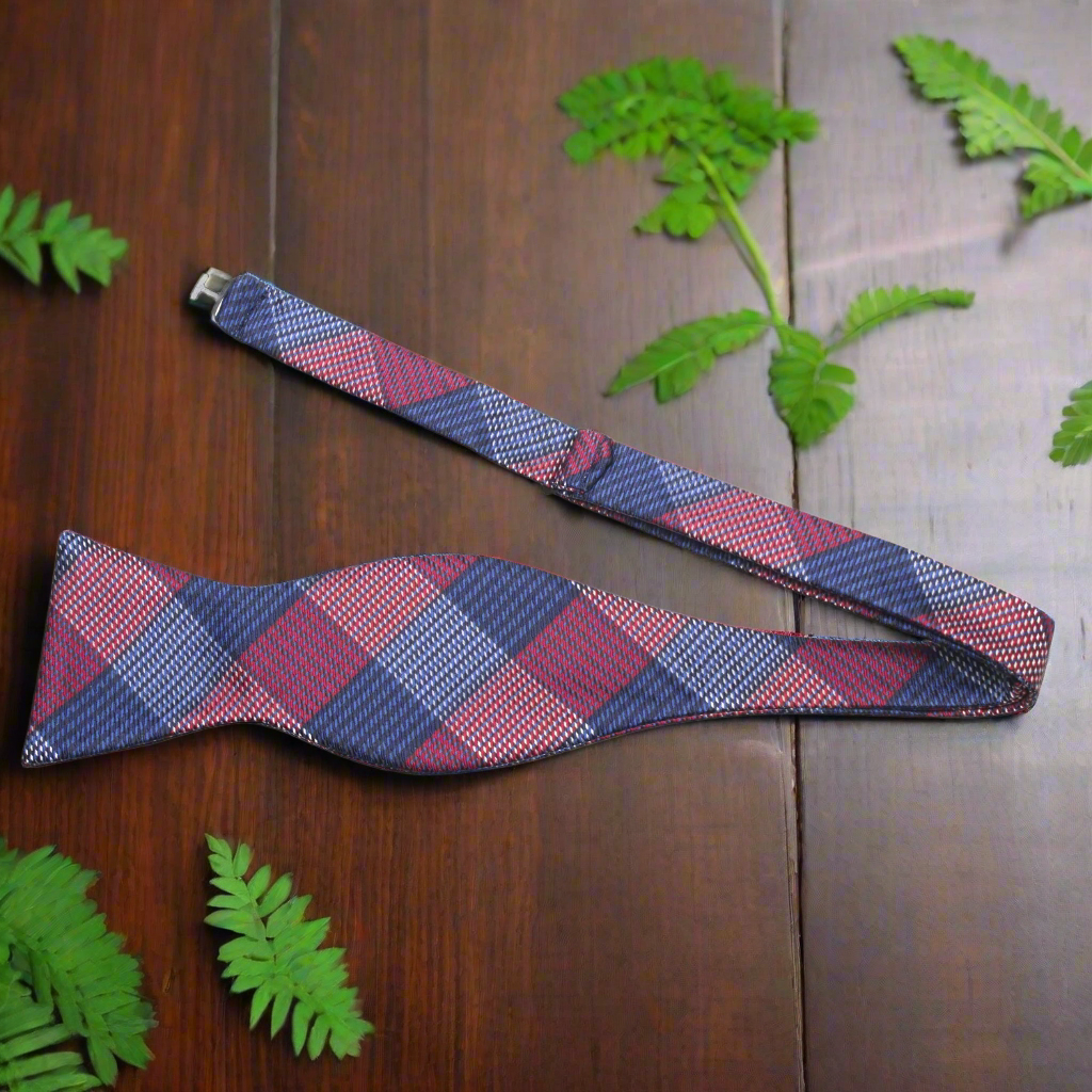 Model wearing pre-tied silk bow tie with matching pocket square at a formal event