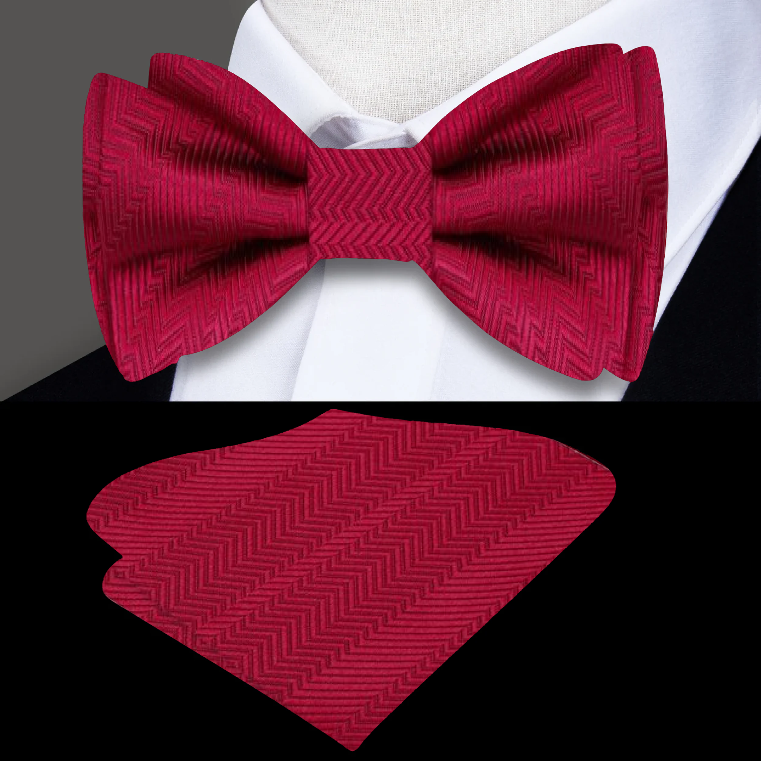 Stylish garnet red silk bow tie paired with a matching pocket square on a navy blue suit jacket, ideal for weddings.