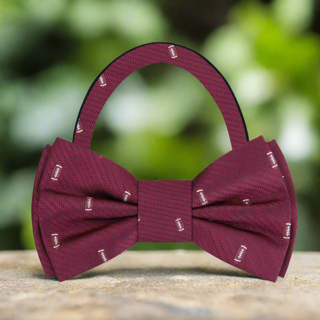 Close-up of the intricate football pattern on a silk bow tie, showcasing its luxurious fabric.