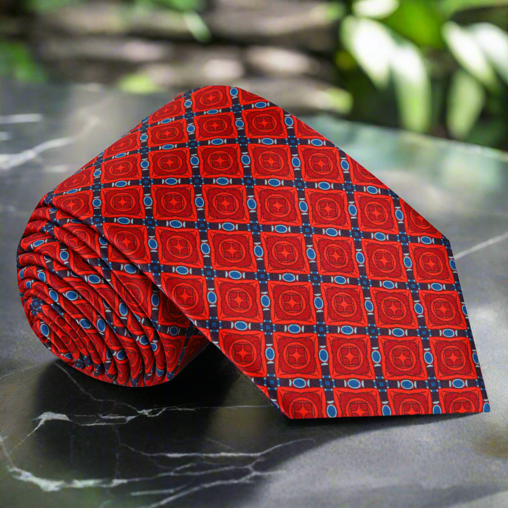Close-up of red geometric silk tie with intricate pattern