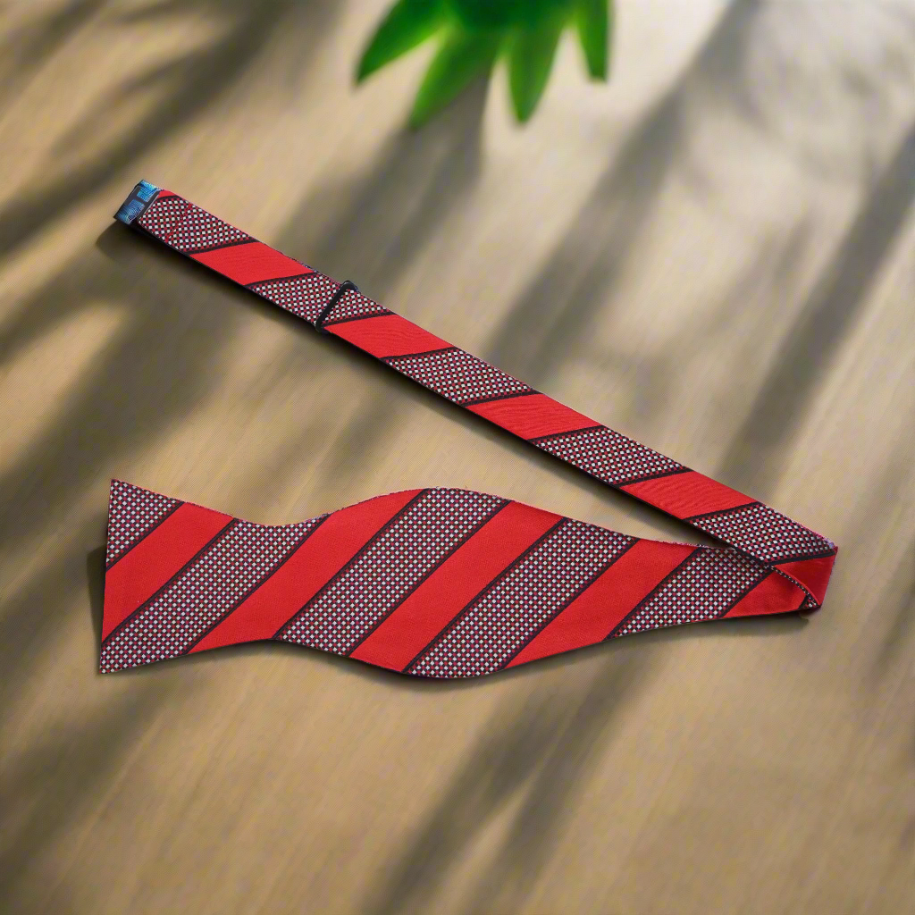 Close-up view of grey silk bow tie showcasing its intricate blue stripe pattern
