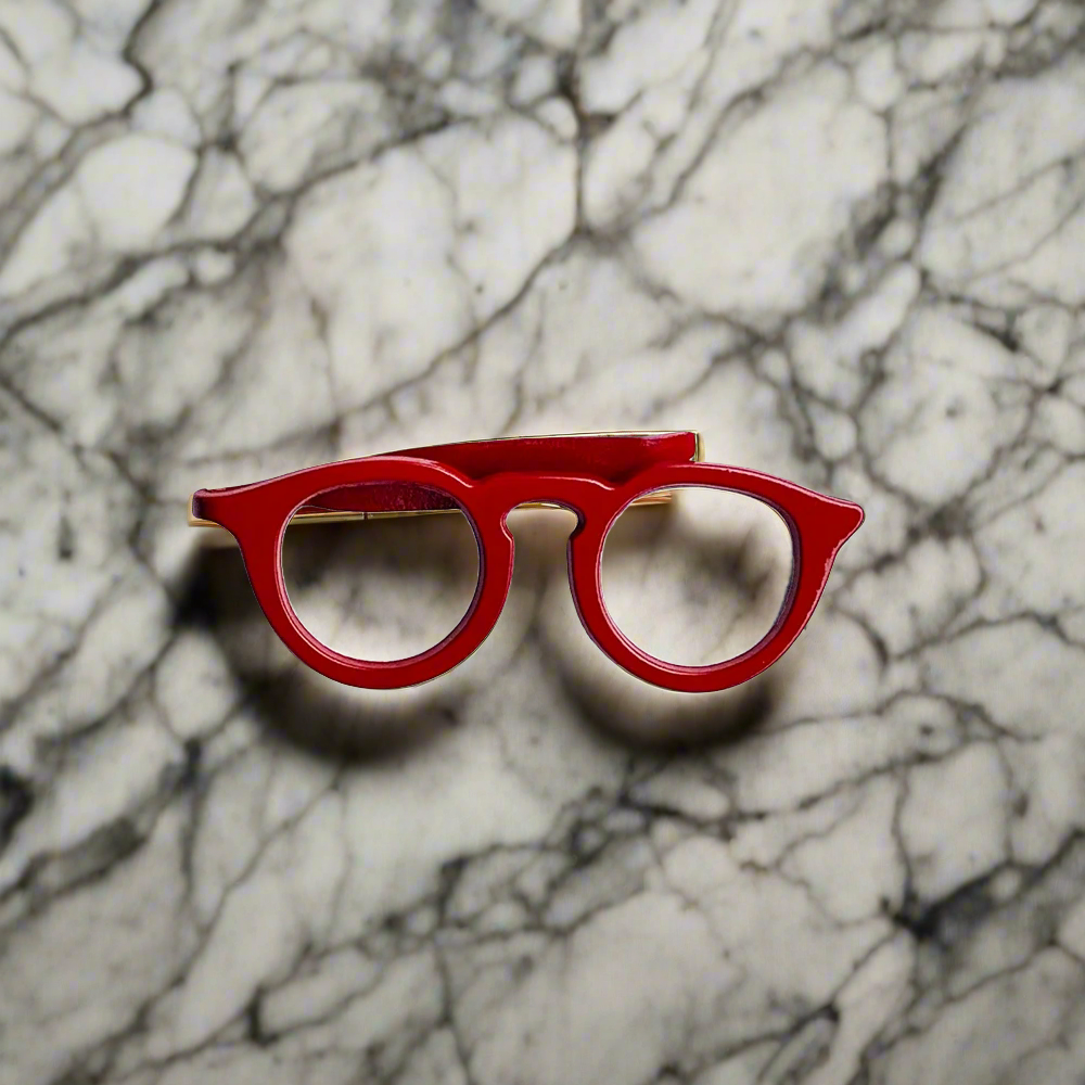 Close-up of a glasses tie clip attached to a white dress shirt for formal wear