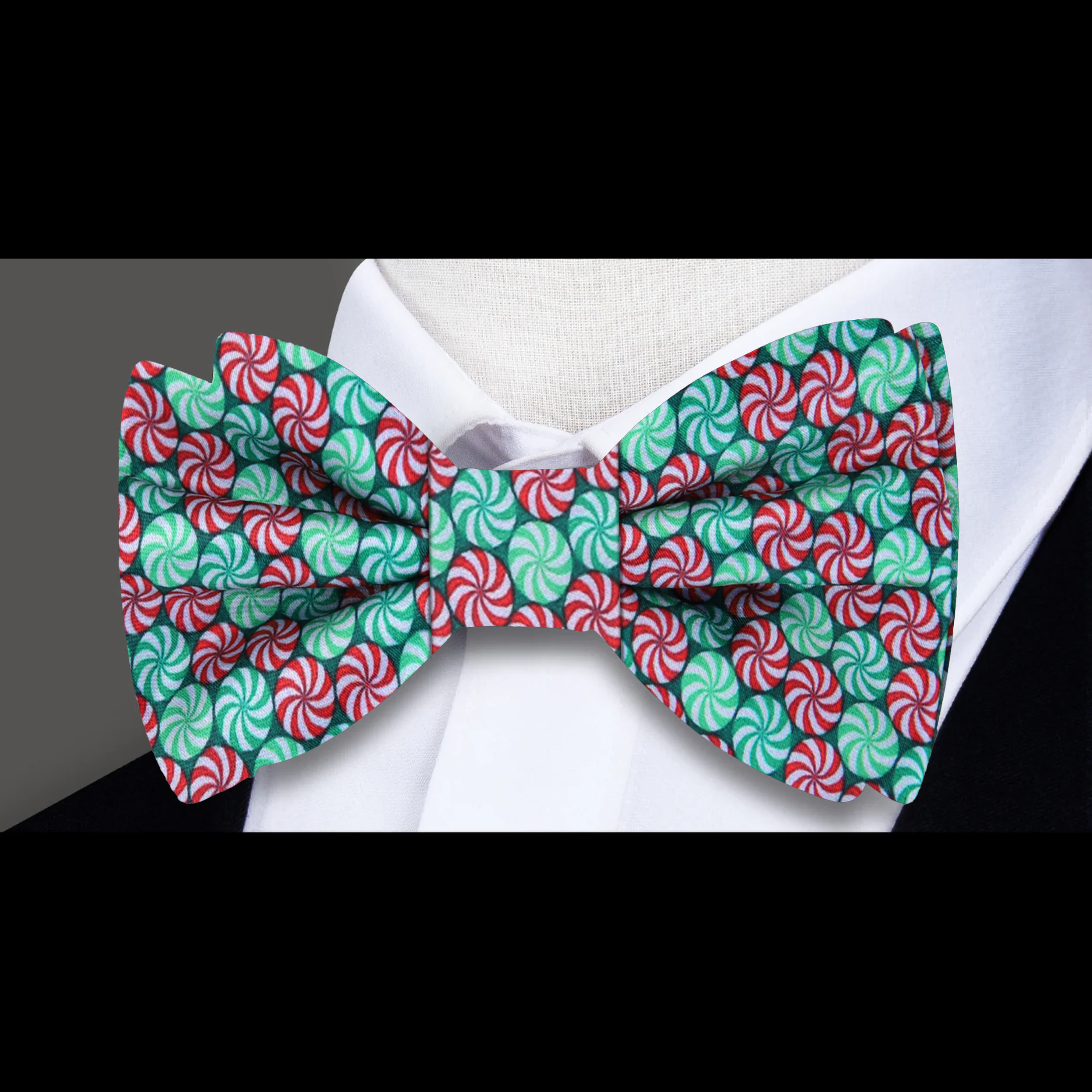 Close-up of Christmas Candy Bow Tie with vibrant red, green, and white candy pattern