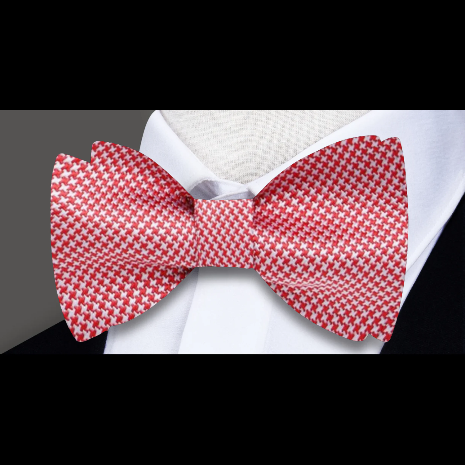 Close-up of a red houndstooth silk bow tie on a dress shirt for formal events
