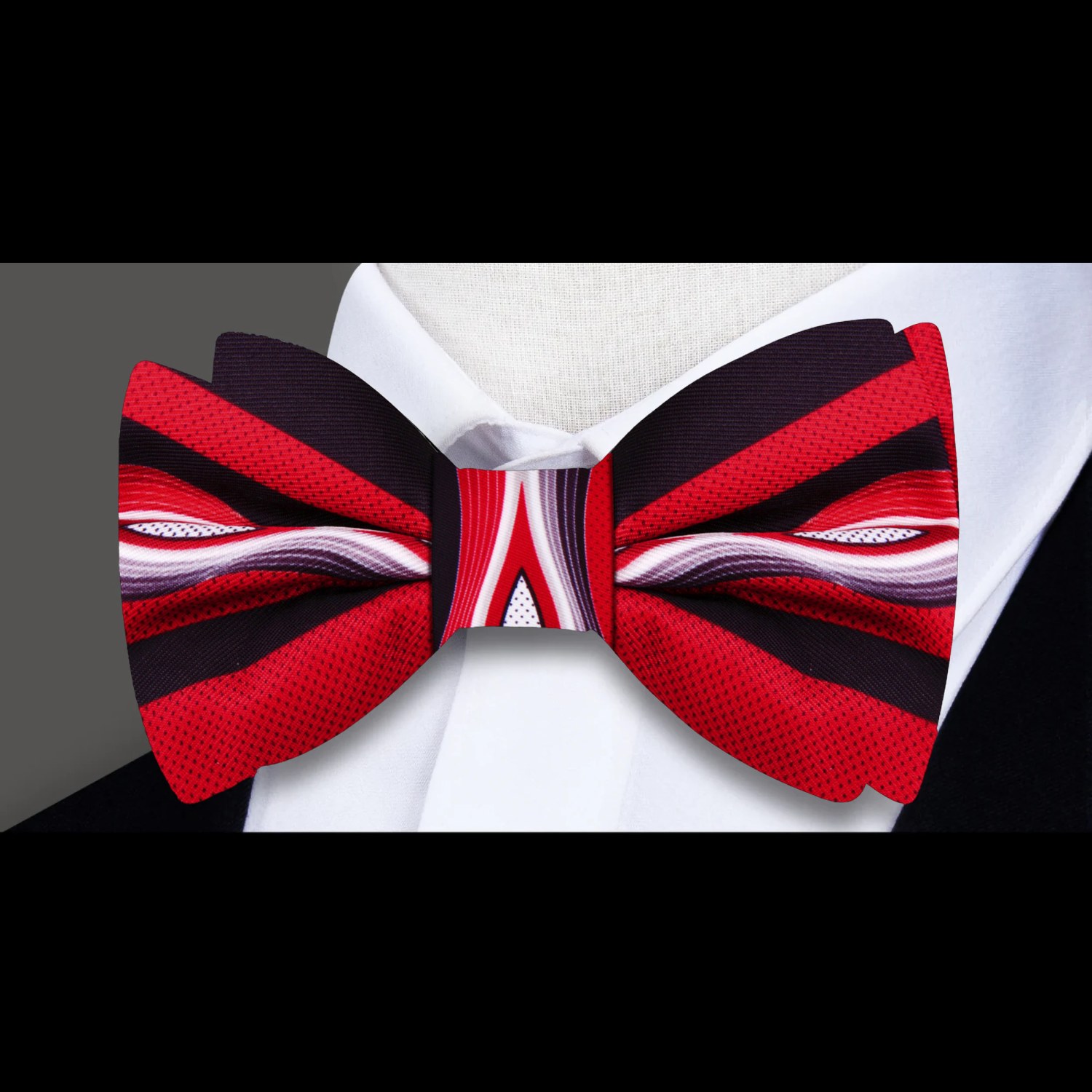 Model wearing the Abstract Waves Silk Bow Tie at a formal event, paired with a tailored black suit
