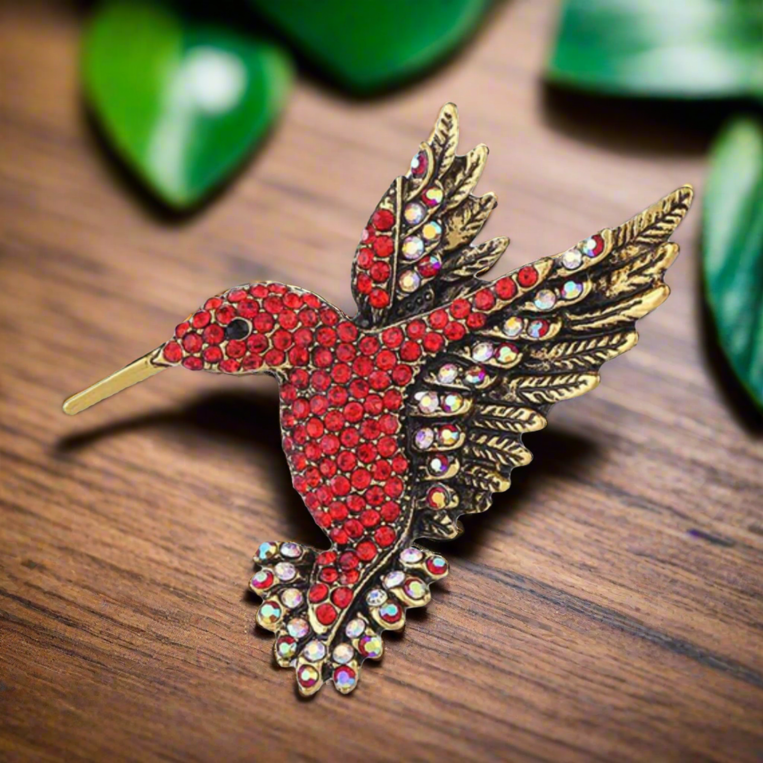 Close-up view of the vibrant hummingbird lapel pin showcasing its intricate design and shimmering gemstones.