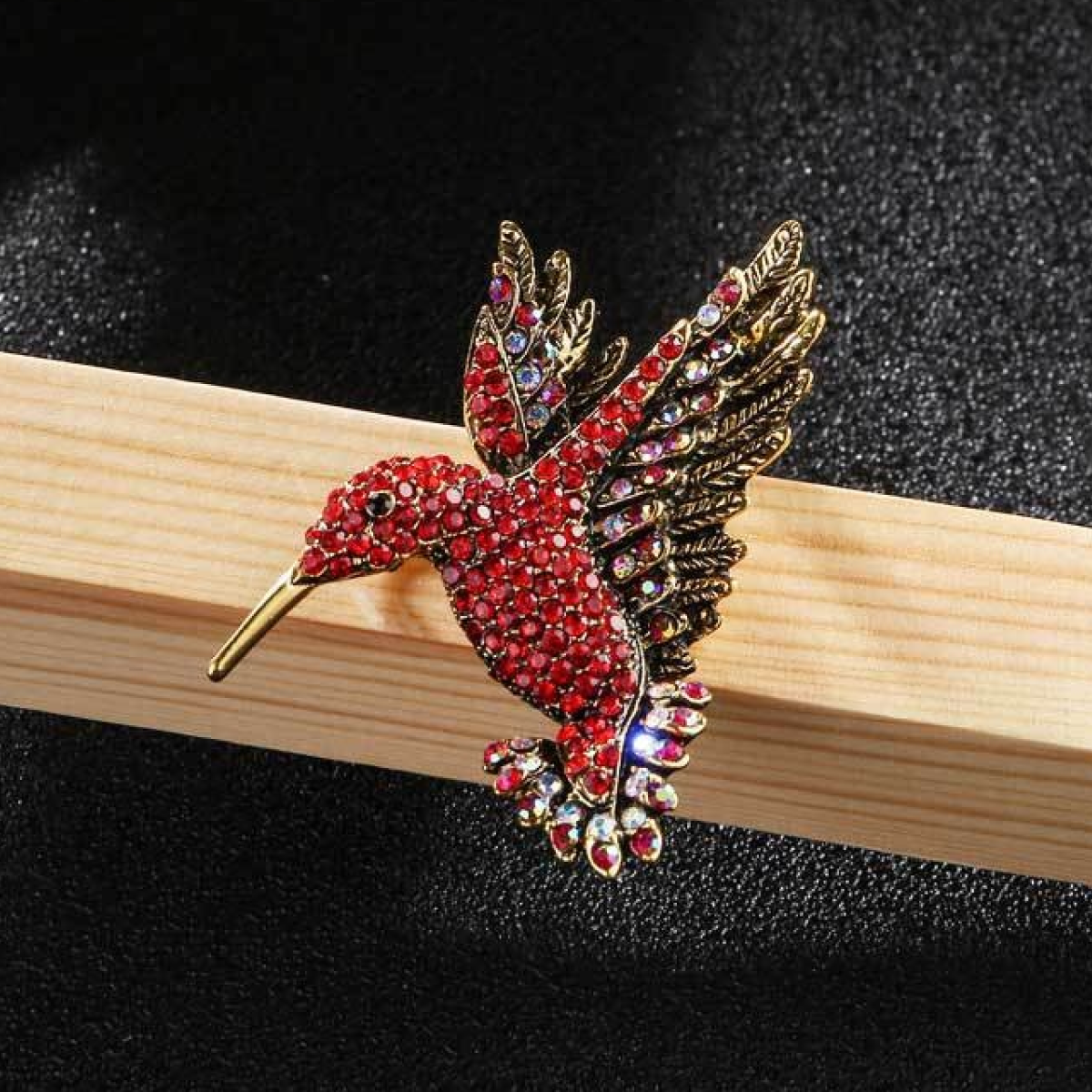 Elegant hummingbird pin displayed on a stylish blazer, enhancing the outfit with a touch of nature-inspired charm.