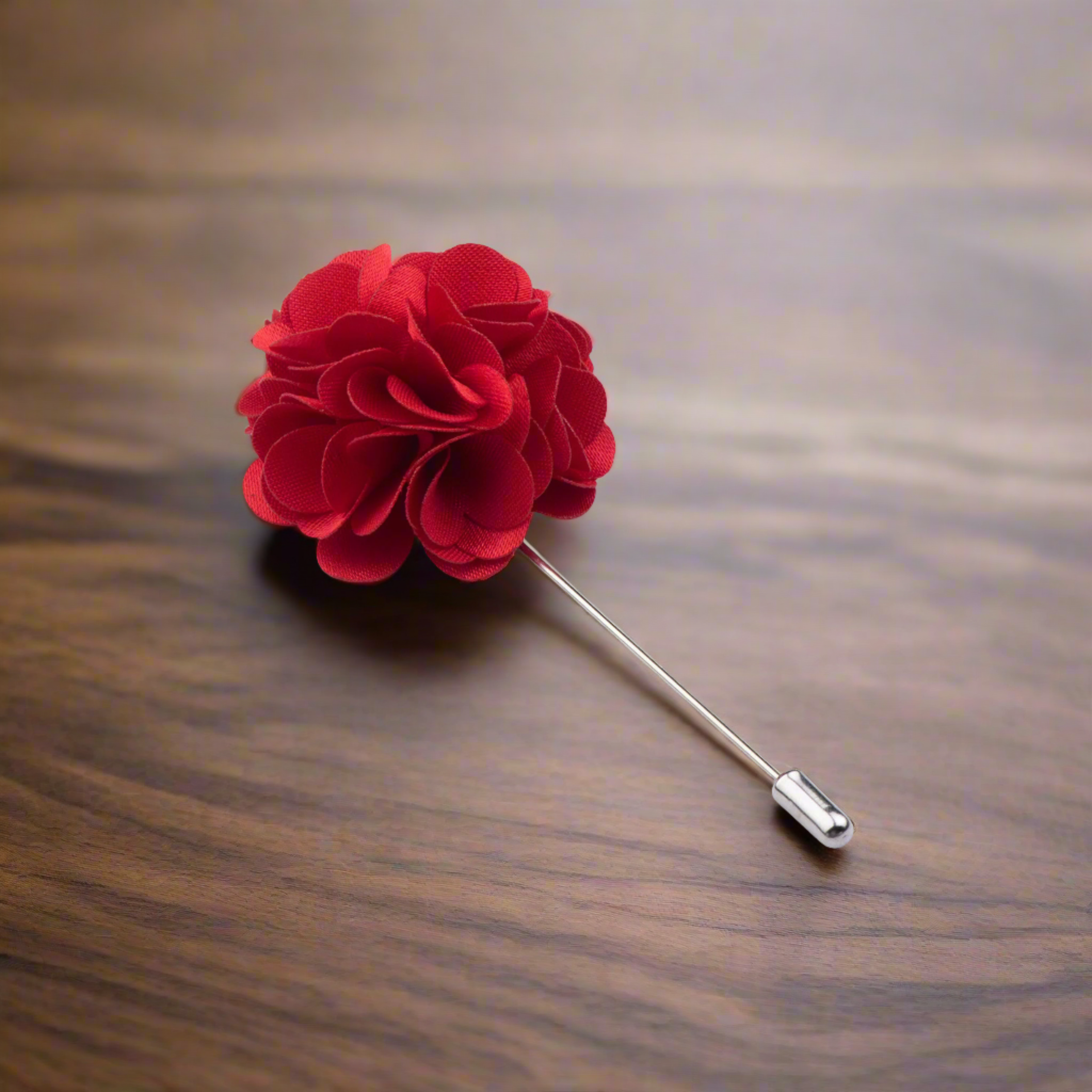 Close-up of teal flower lapel pin on a men's suit collar for wedding guest look