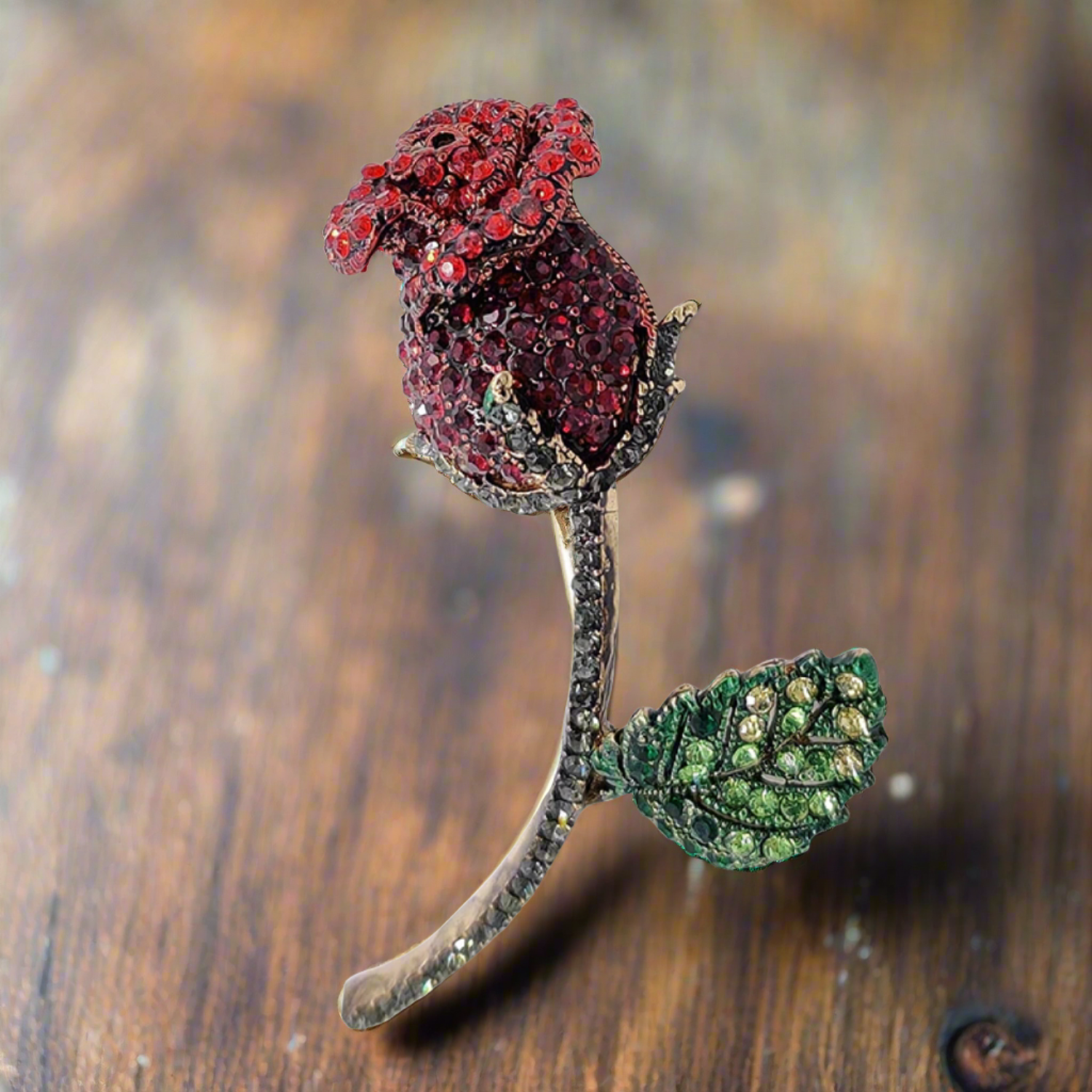 Close-up of a red rose lapel pin with sparkling gemstones, ideal for formal events.