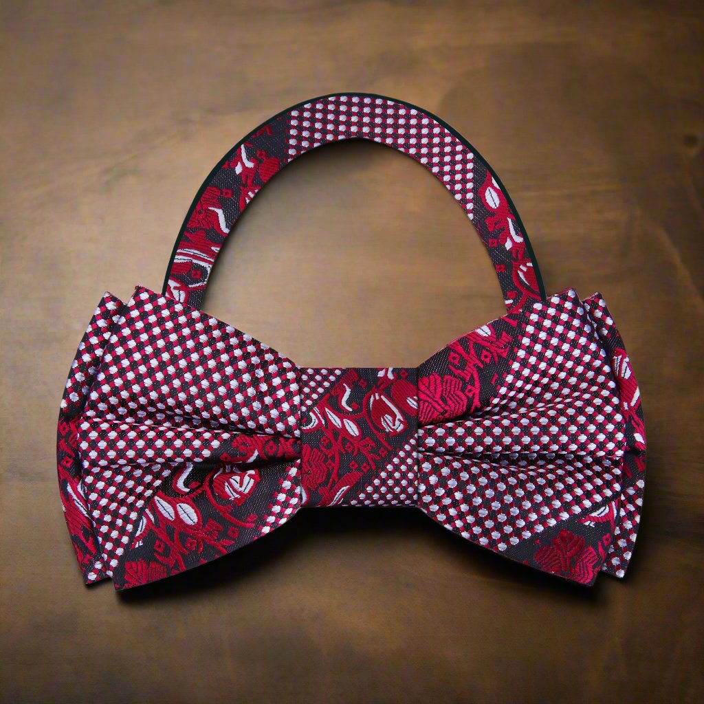 Styled shot of silk bow tie paired with white dress shirt and suit, ideal for upscale gatherings