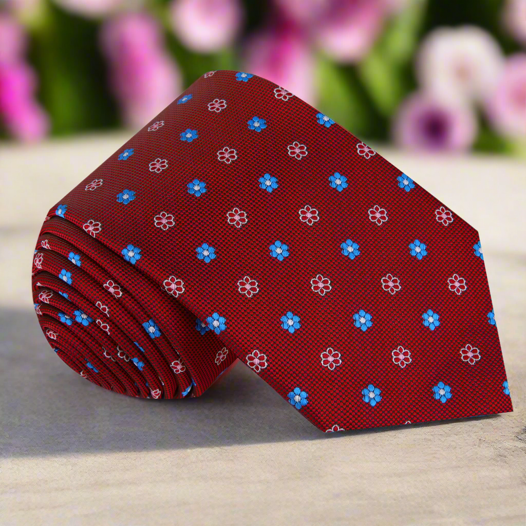 Close-up of red floral necktie showing intricate flower patterns.