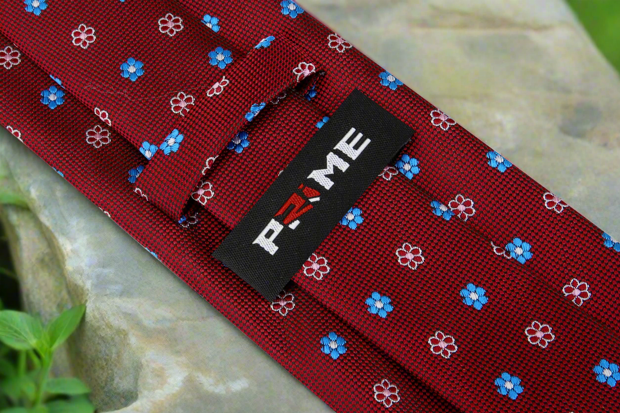 Red silk necktie styled with a navy suit and white dress shirt.