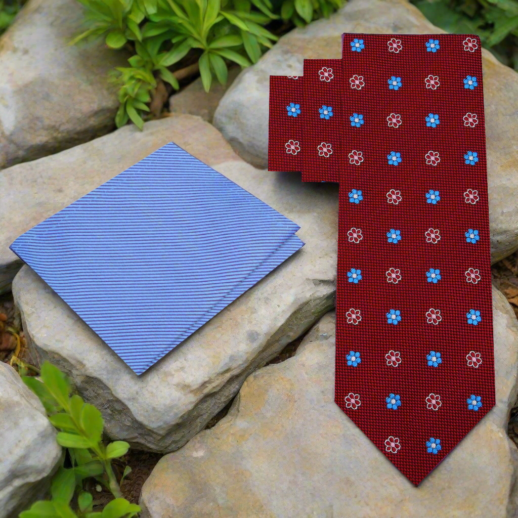 Close-up of red floral necktie showing intricate flower patterns.
