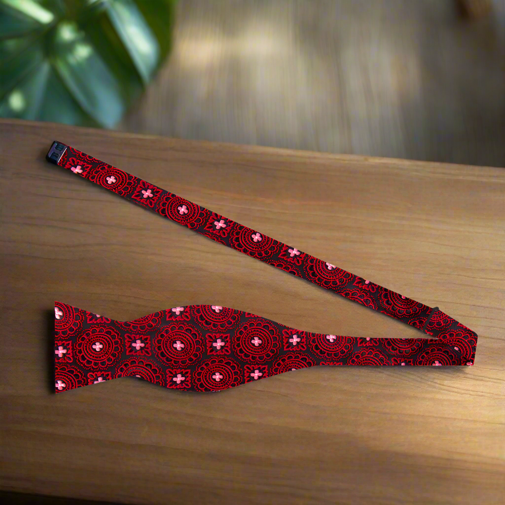 Crimson Burst Silk Bow Tie paired with a charcoal grey suit, emphasizing its elegance for formal occasions.