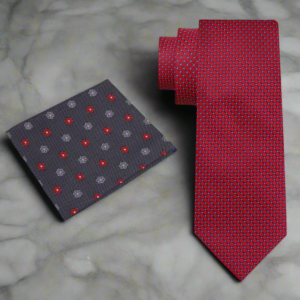 Close-up of the deep red silk neckties geometric design, highlighting its richness and texture.