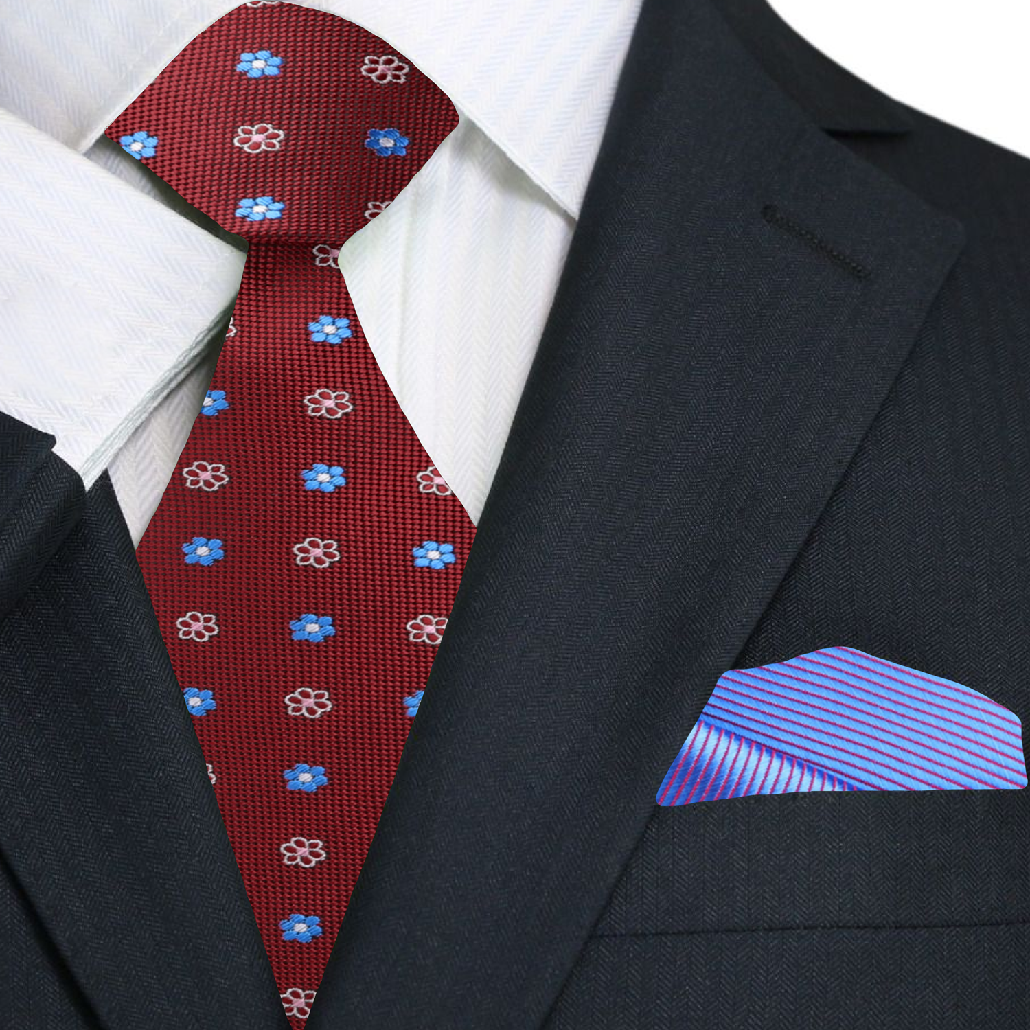 Red silk necktie styled with a navy suit and white dress shirt.