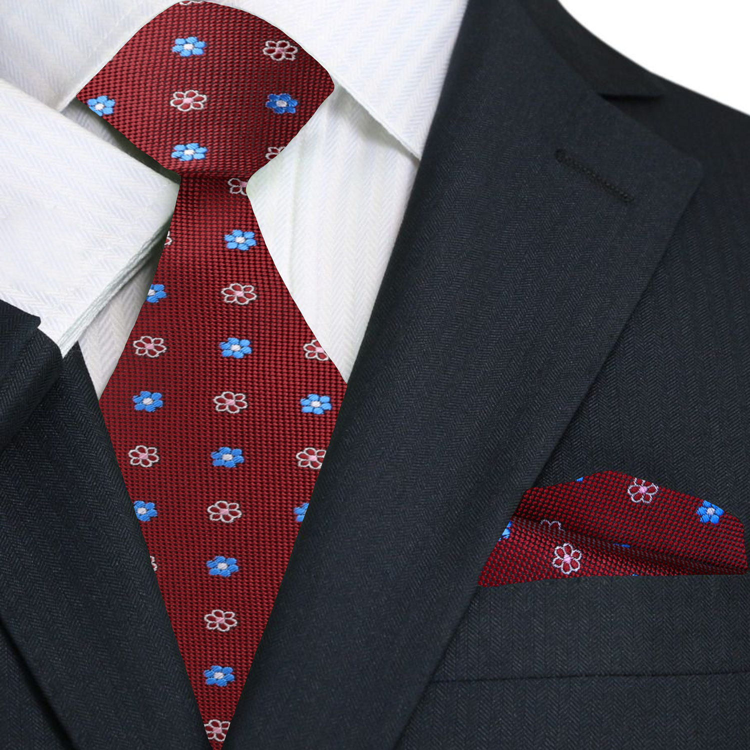 Red silk necktie styled with a navy suit and white dress shirt.