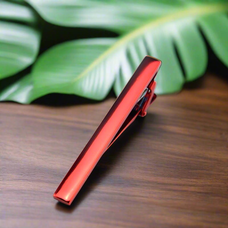 Close-up of polished chrome tie bar clipped onto navy silk tie