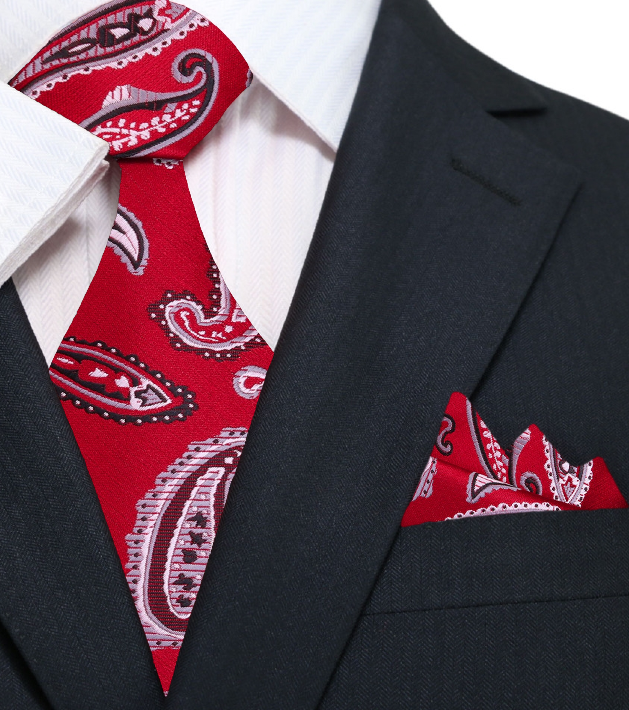 Blue paisley silk tie elegantly draped over a grey suit, perfect for business meetings.