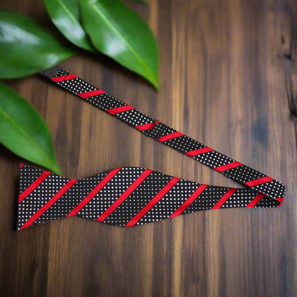 Close-up of silk bow tie showcasing intricate stripes and polka dots.