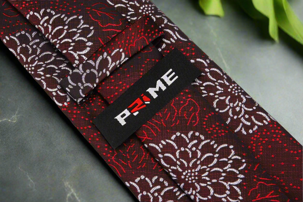 Close-up of the red tie showcasing intricate Zinnia flowers.