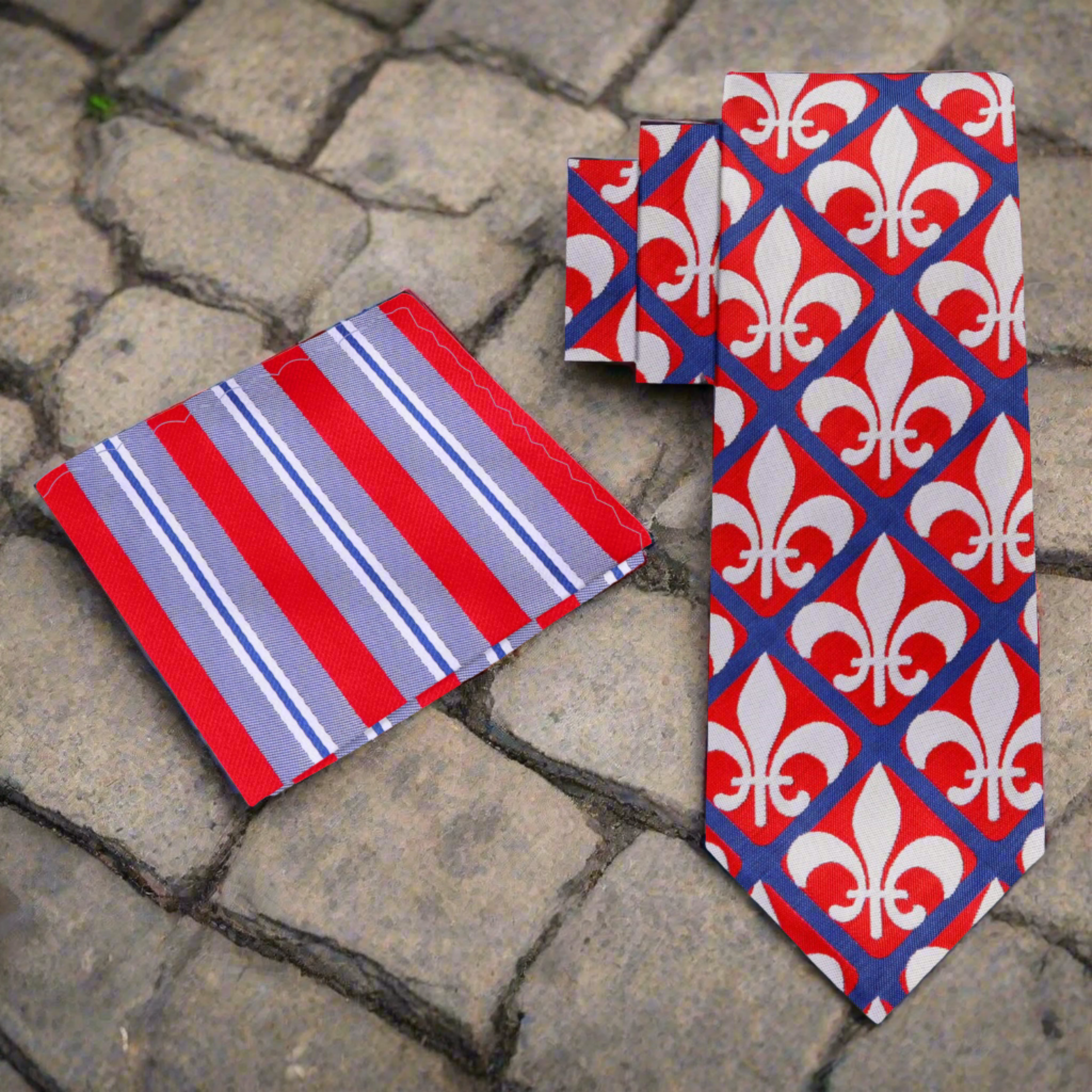 Close-up of fleur-de-lis tie and pocket square set on a wooden table.