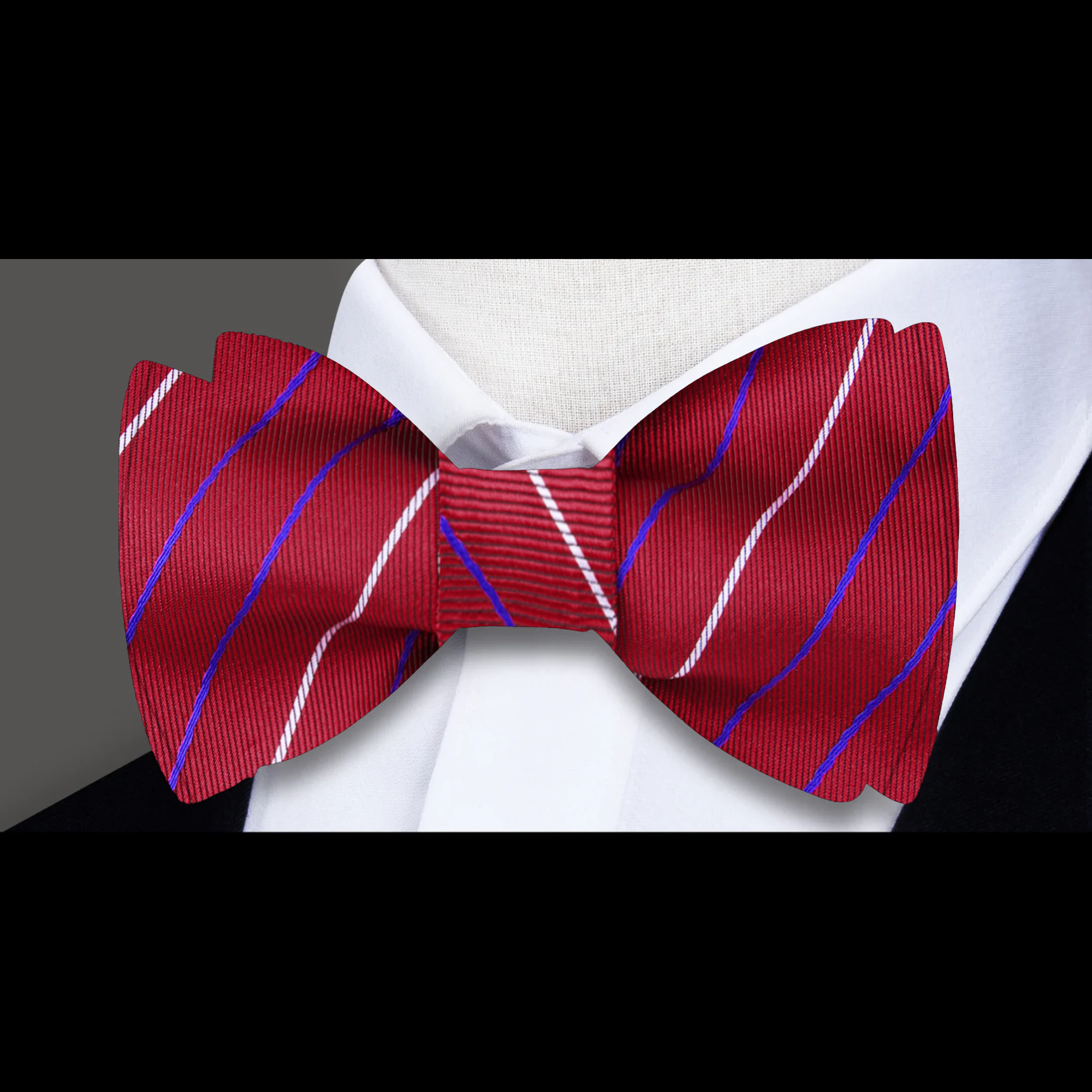 A stylish man wearing a blue and red striped bow tie at a wedding, exuding confidence and elegance.