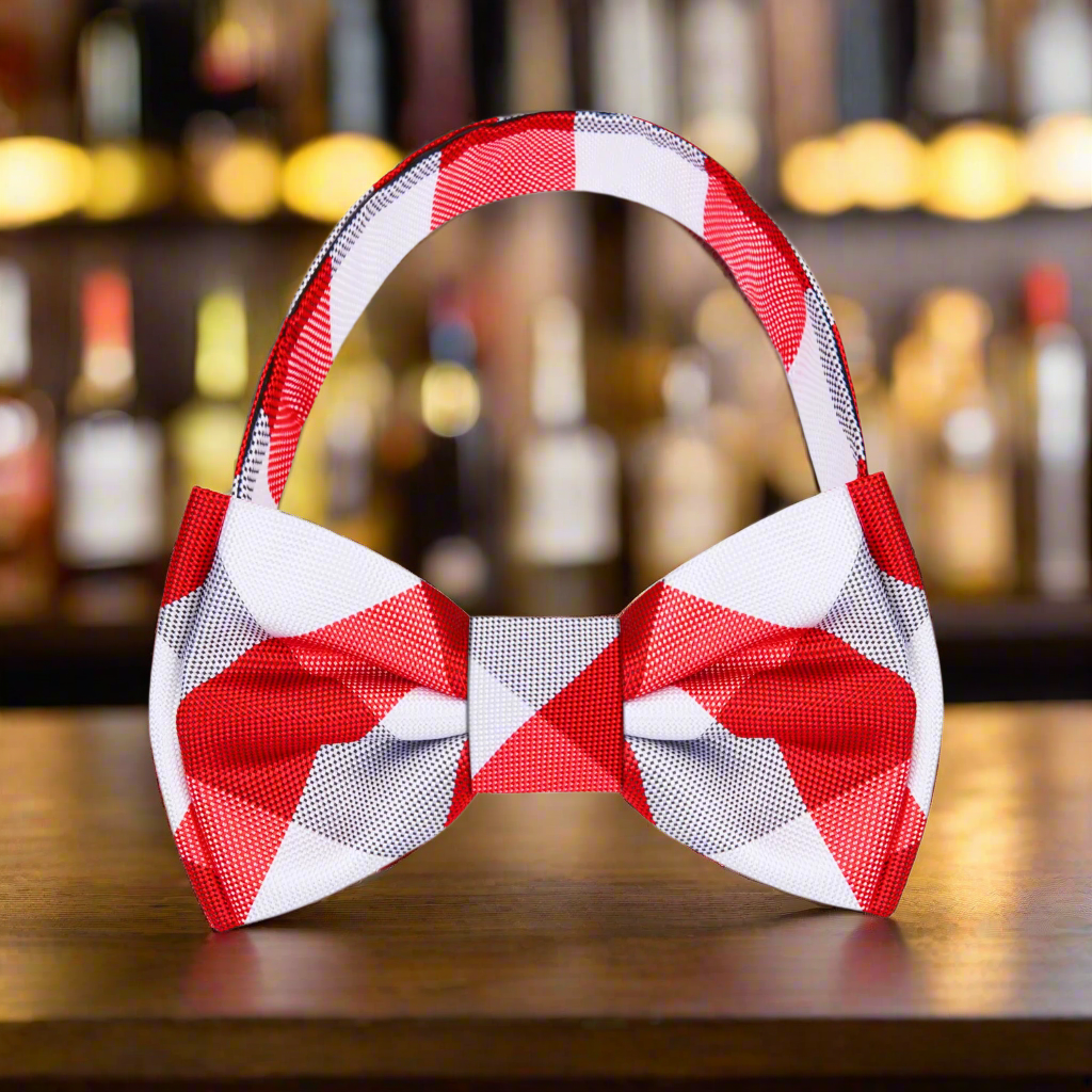 Classic red and white plaid silk bow tie showcased against a white shirt.