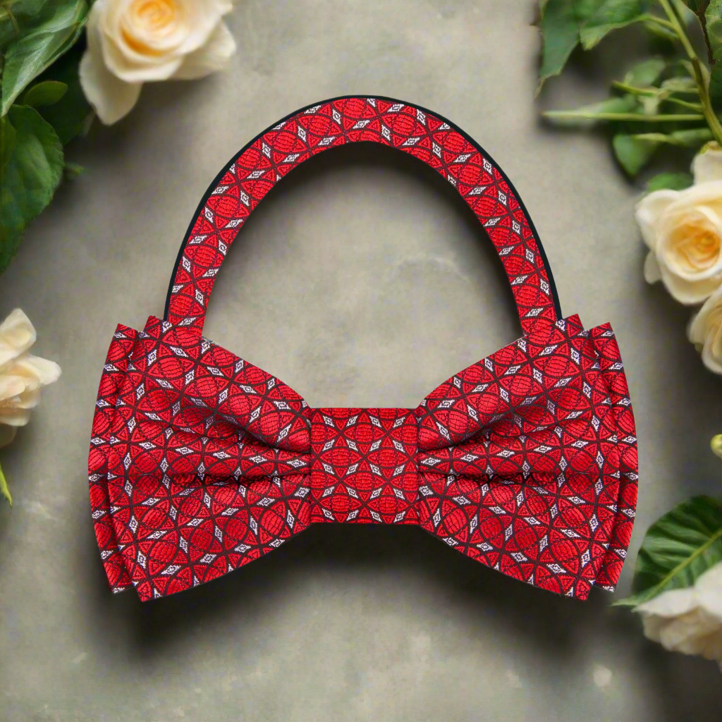 Model wearing the red and grey geometric bow tie with a navy suit, ideal for formal occasions.