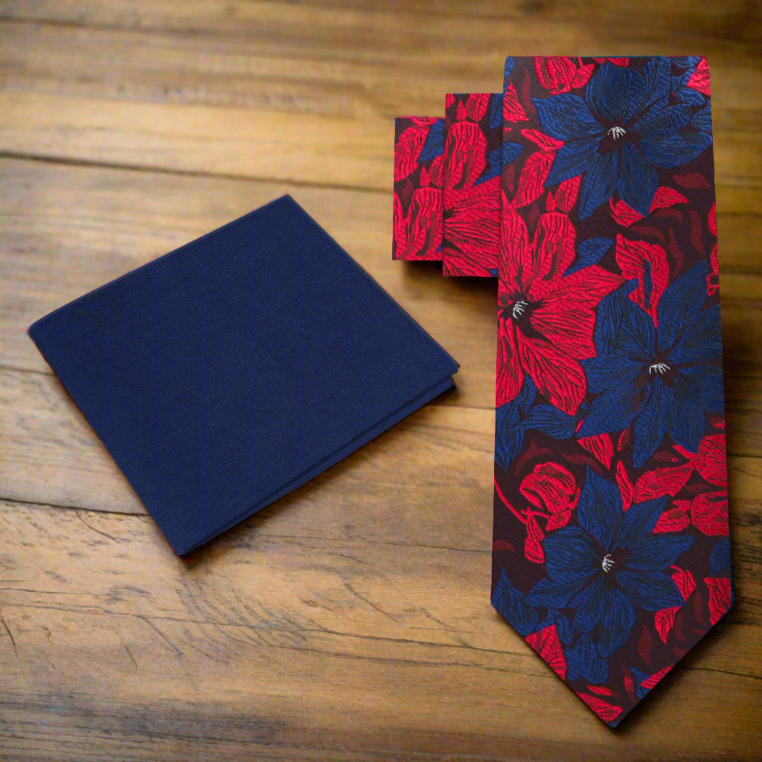 A flat lay of the hibiscus floral tie on a suit jacket, highlighting its versatility for formal events.