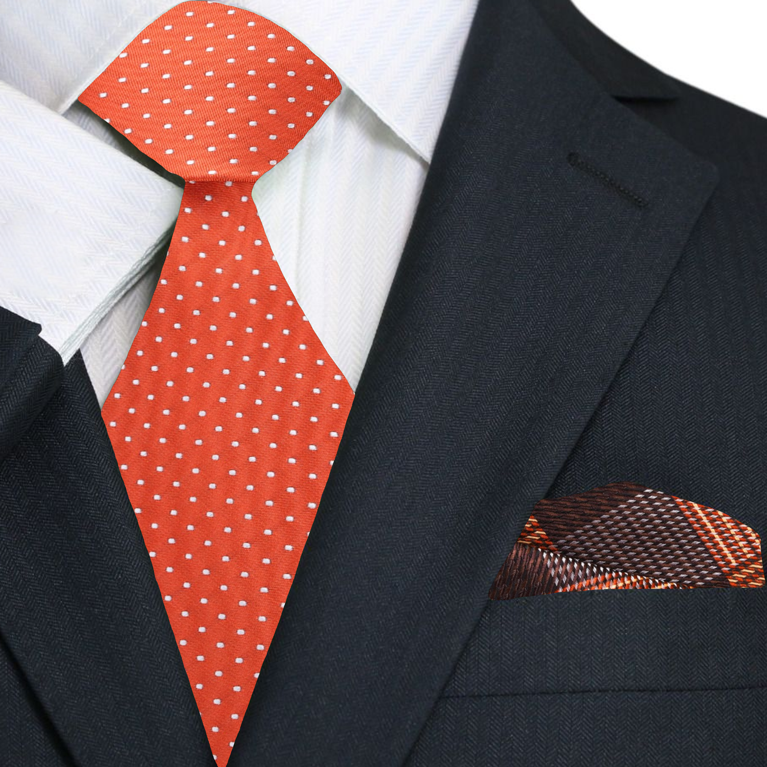 The reddish orange polka dot necktie styled with a crisp white dress shirt for a formal business look.