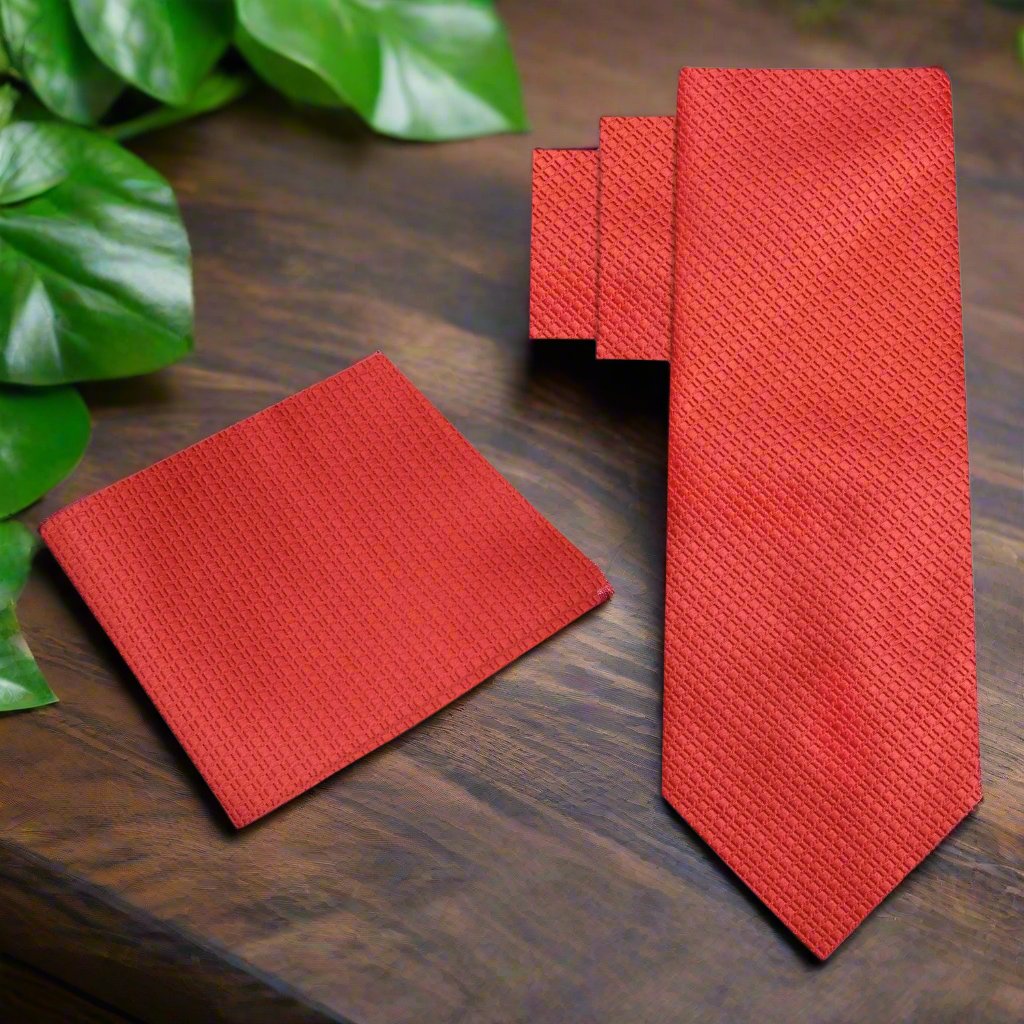 Close-up of red textured silk necktie showing geometric pattern and rich color