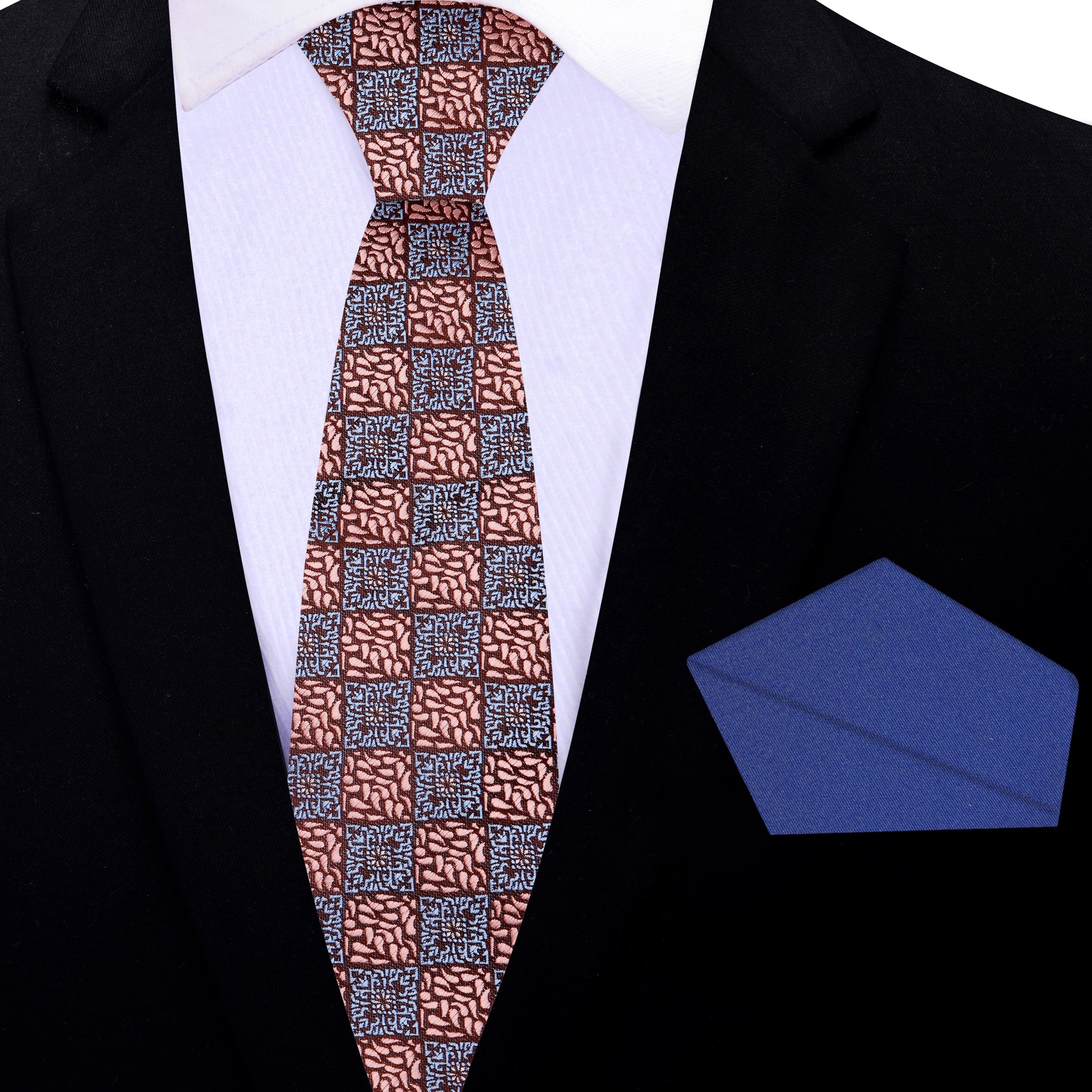 Flat lay of the rose gold geometric necktie and matching pocket square on a neutral background.