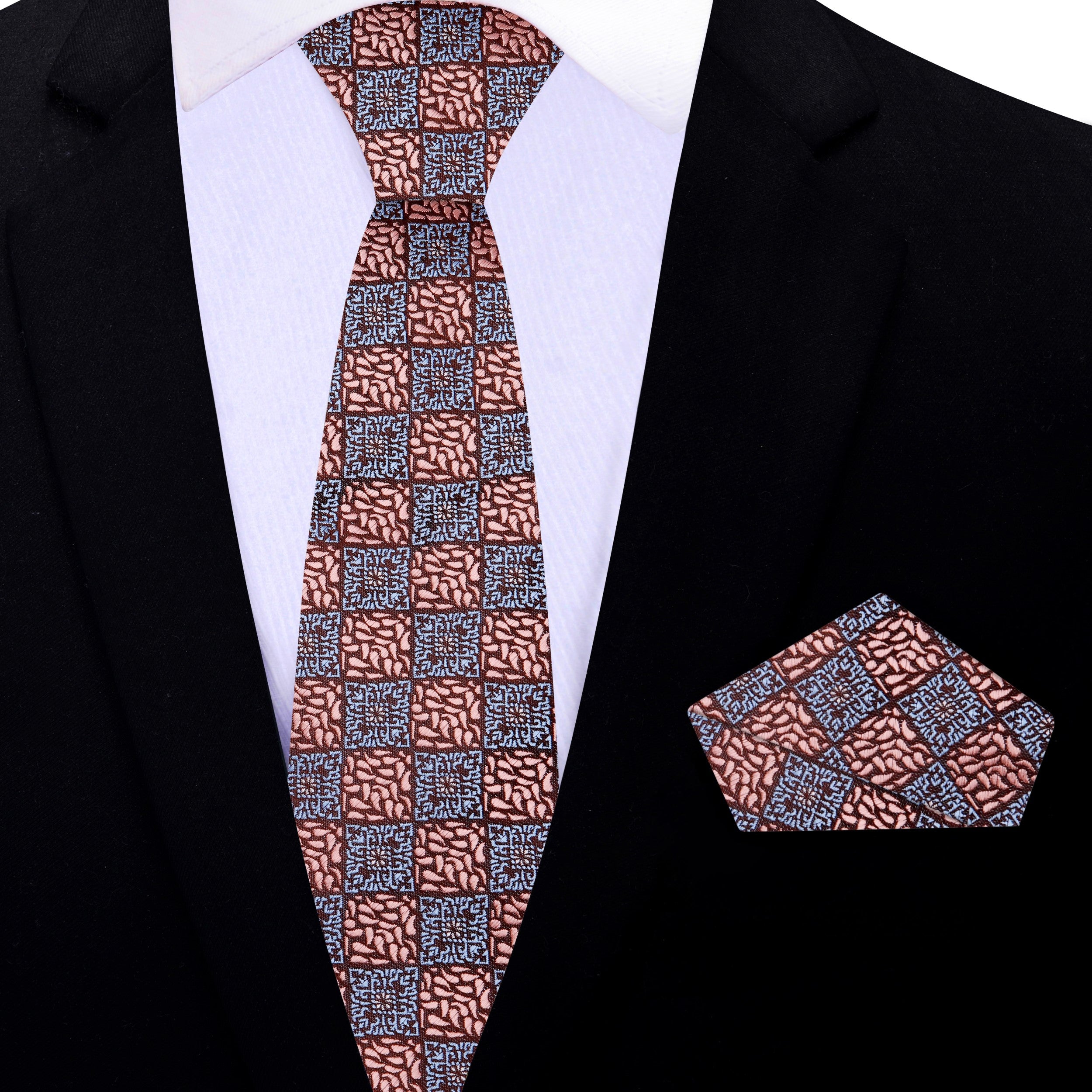 Flat lay of the rose gold geometric necktie and matching pocket square on a neutral background.