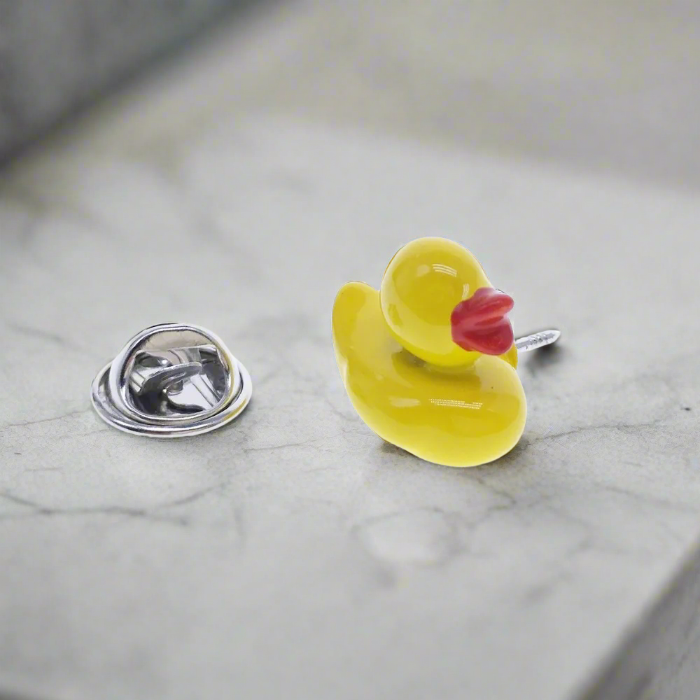 Person wearing rubber duck pin at themed party
