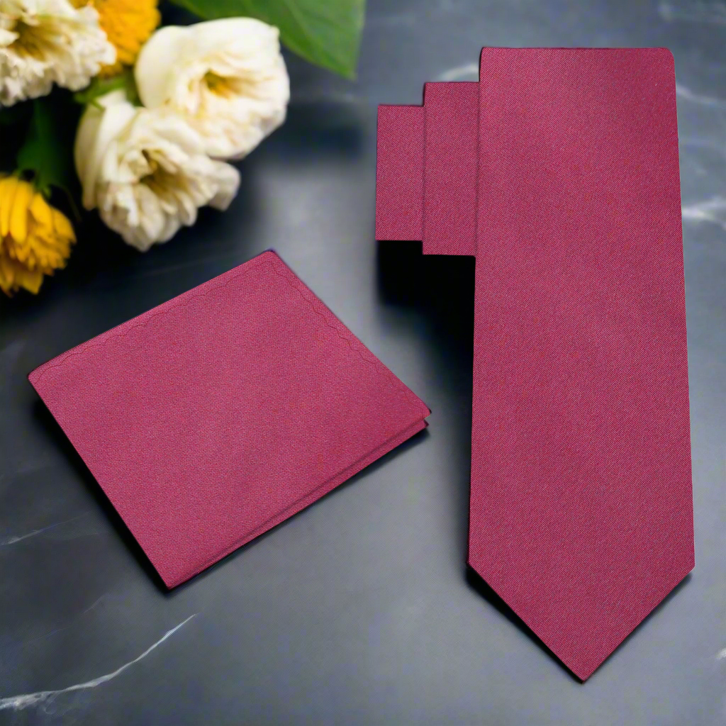 Classic deep red silk necktie draped elegantly over a suit jacket, showcasing its rich color.